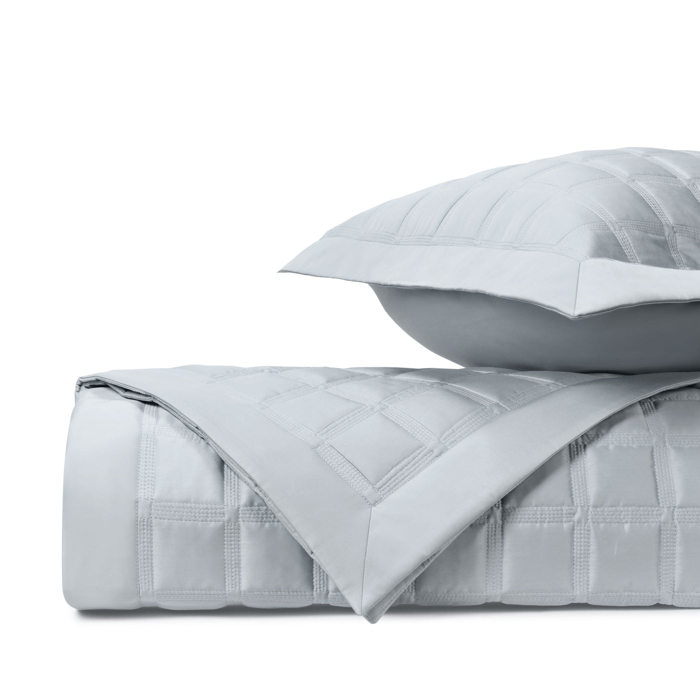 Close-up of Athens quilted coverlet in silver with geometric box-stitched pattern.