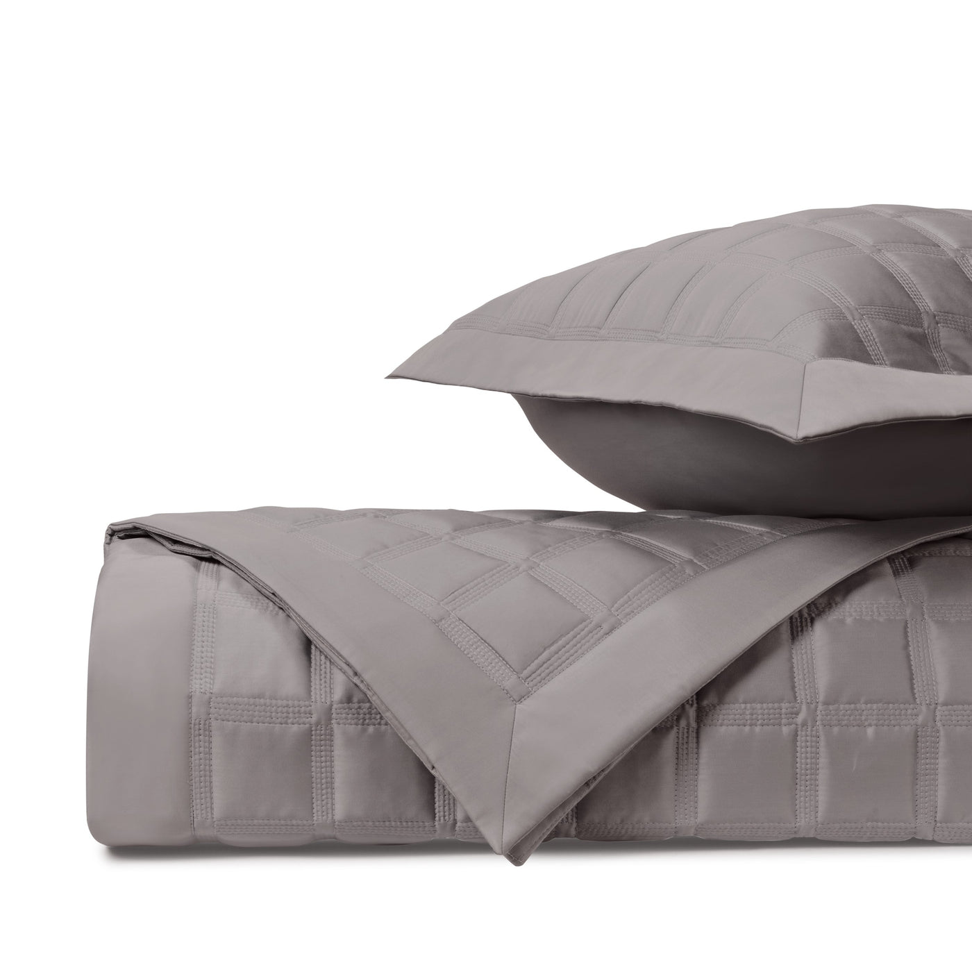 Close-up of Athens quilted coverlet in dove grey with structured grid stitching.