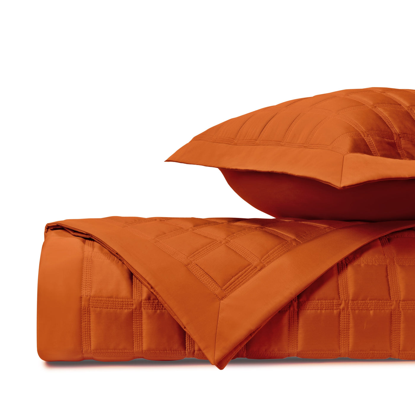 Close-up of Athens quilted satin in tangerine with geometric box-stitch pattern.