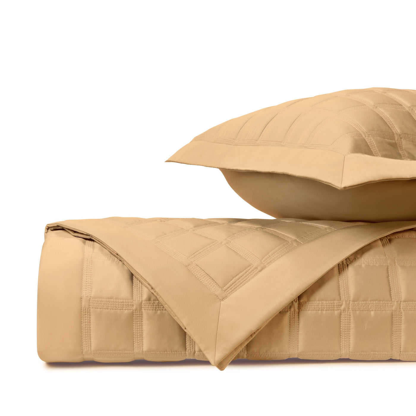 Close-up of Athens quilted satin in caramel, showing block-stitch pattern and sheen.