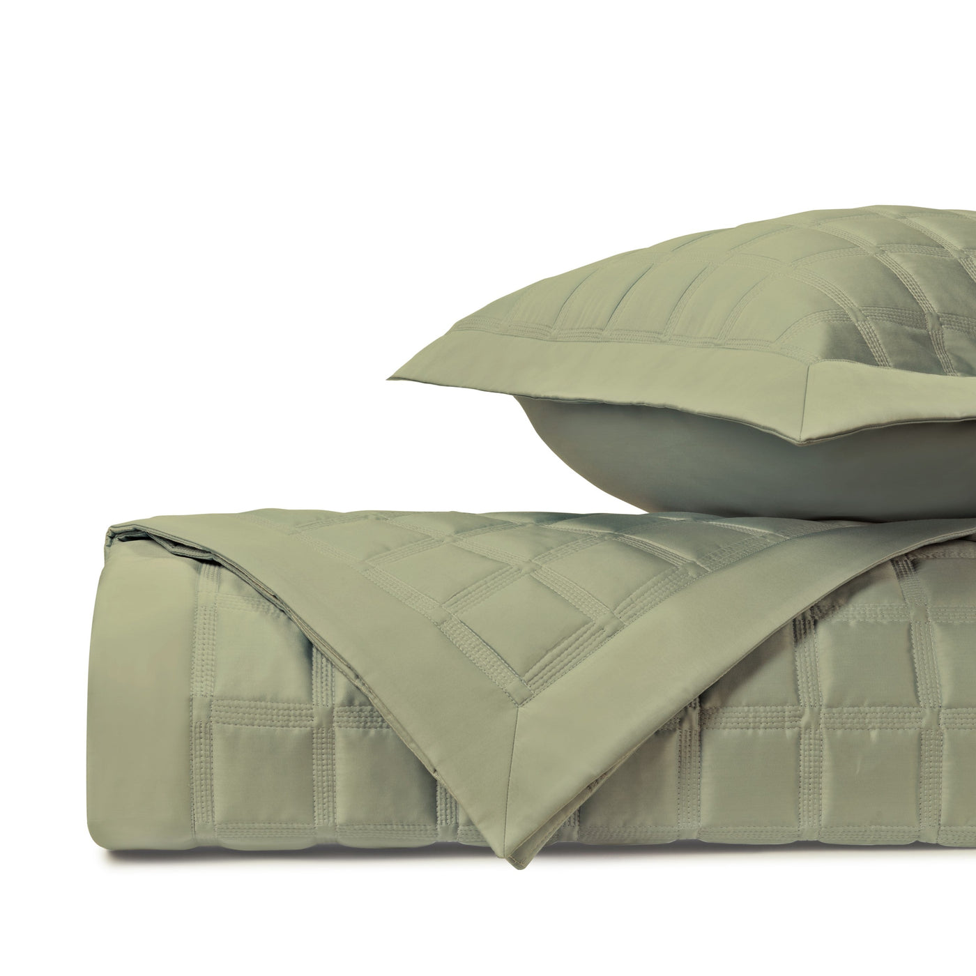 Close-up of Athens quilted coverlet in sage green with geometric stitched pattern.