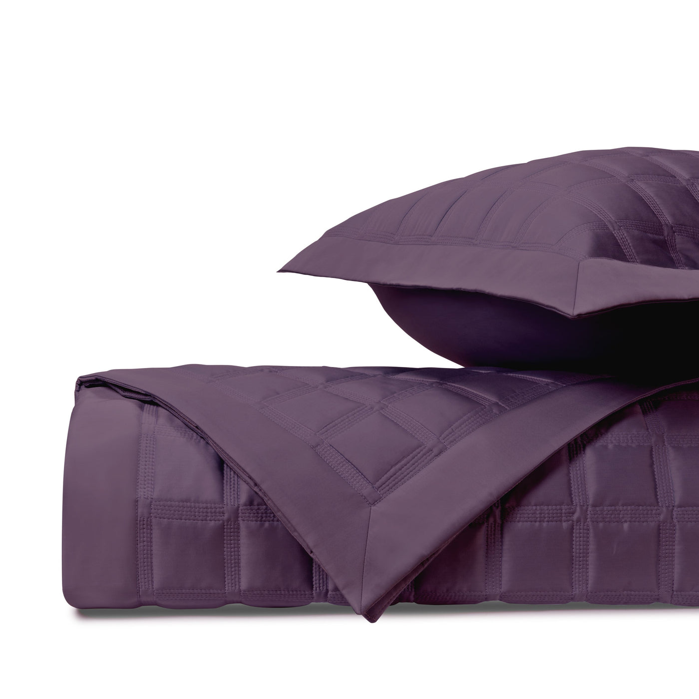 Close-up of Home Treasures Athens quilted coverlet in deep violet with grid stitching.