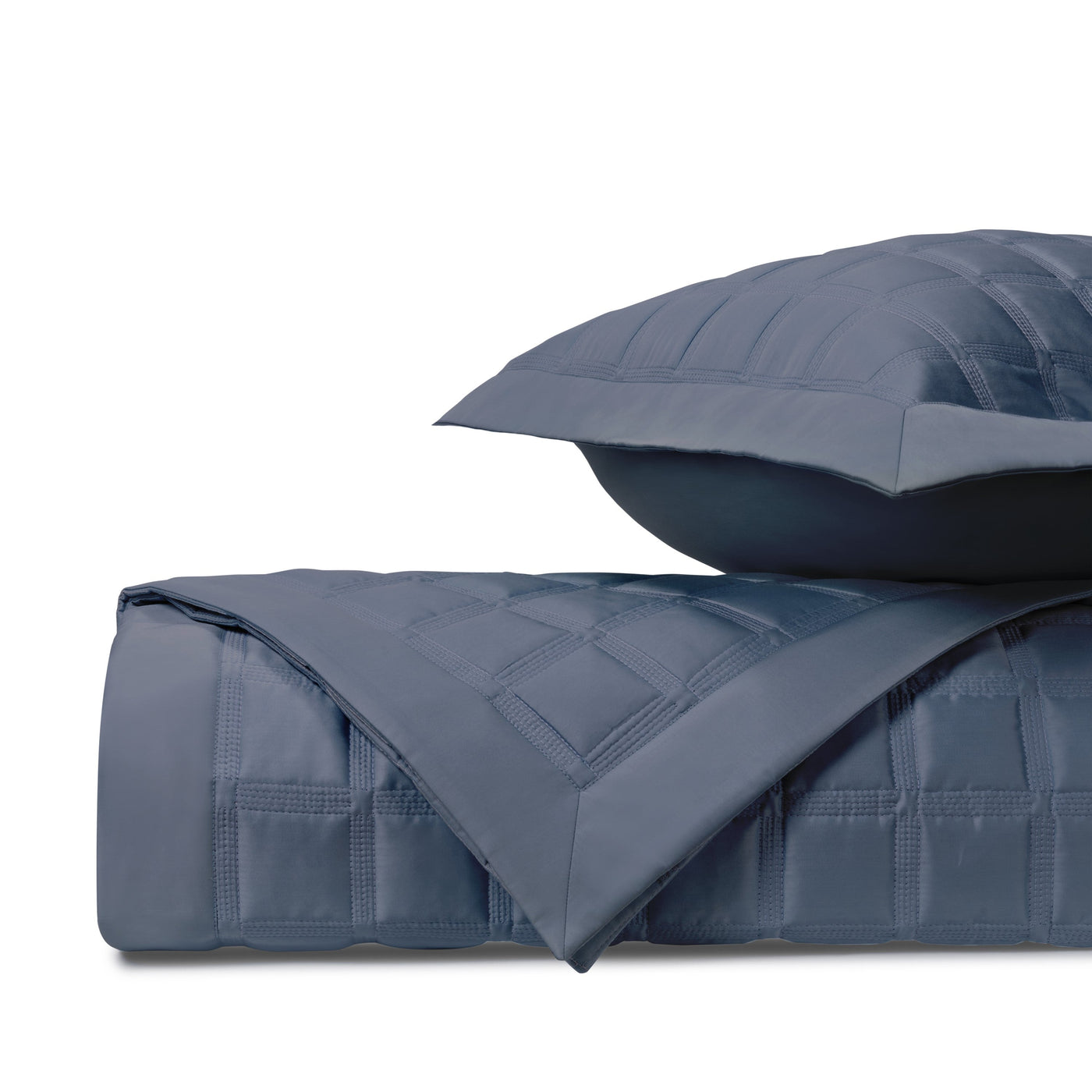 Close-up of Home Treasures Athens quilted cotton in slate blue with grid stitching detail.