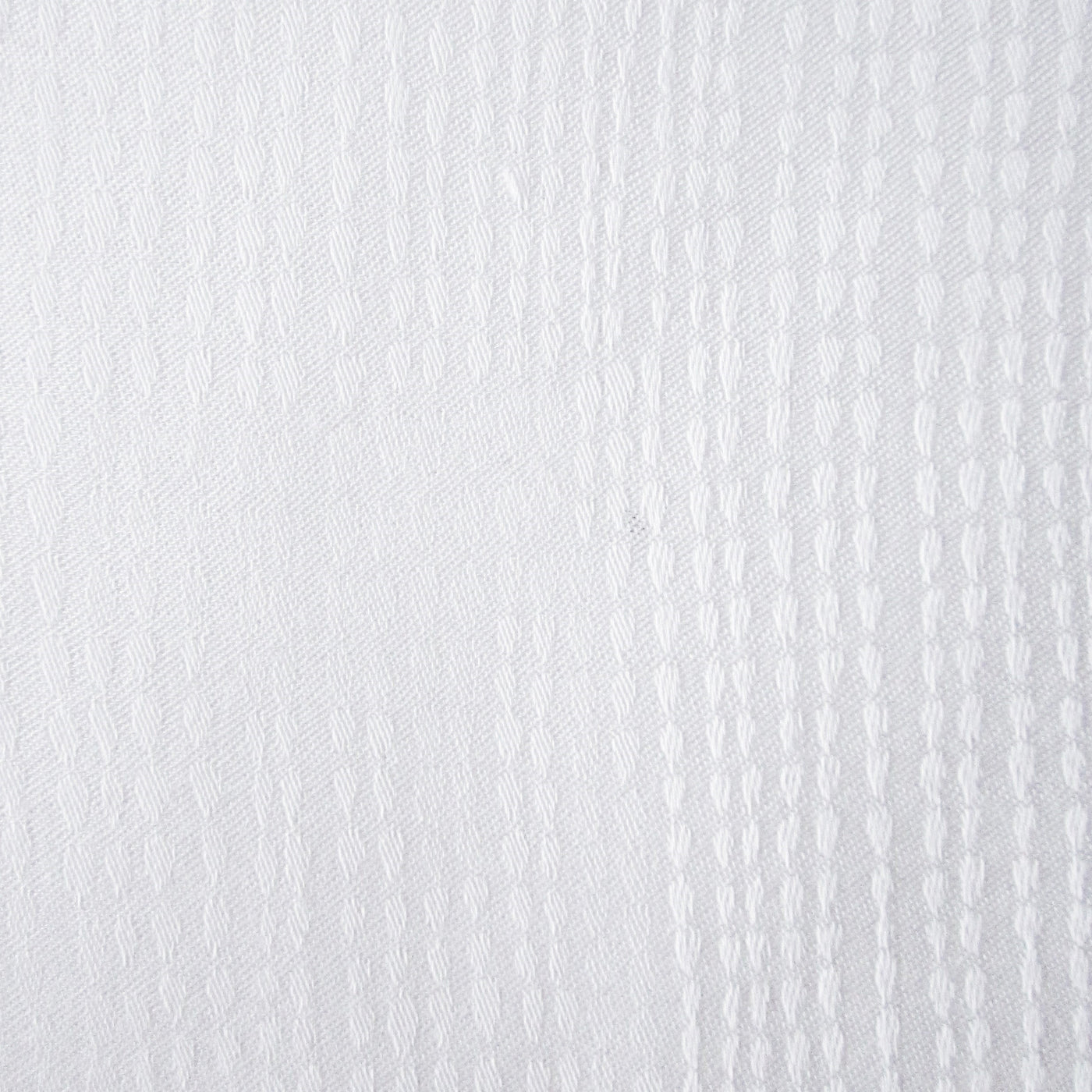 Close-up of Home Treasures Athens white woven texture with vertical stripe relief pattern.