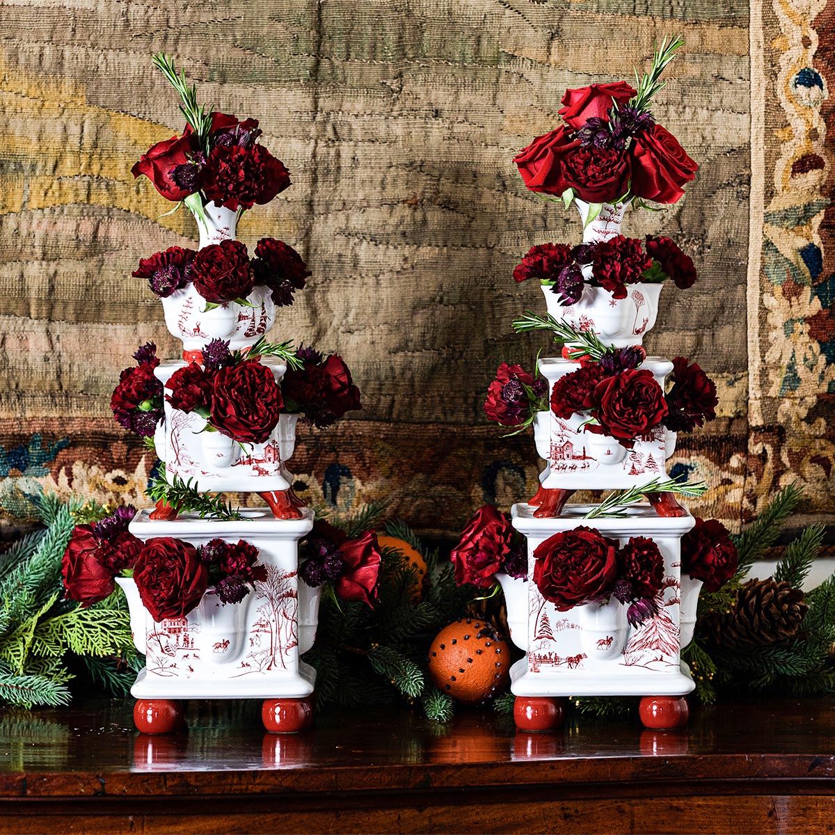 Pair of ruby Winter Frolic tulipieres filled with deep red roses and greenery