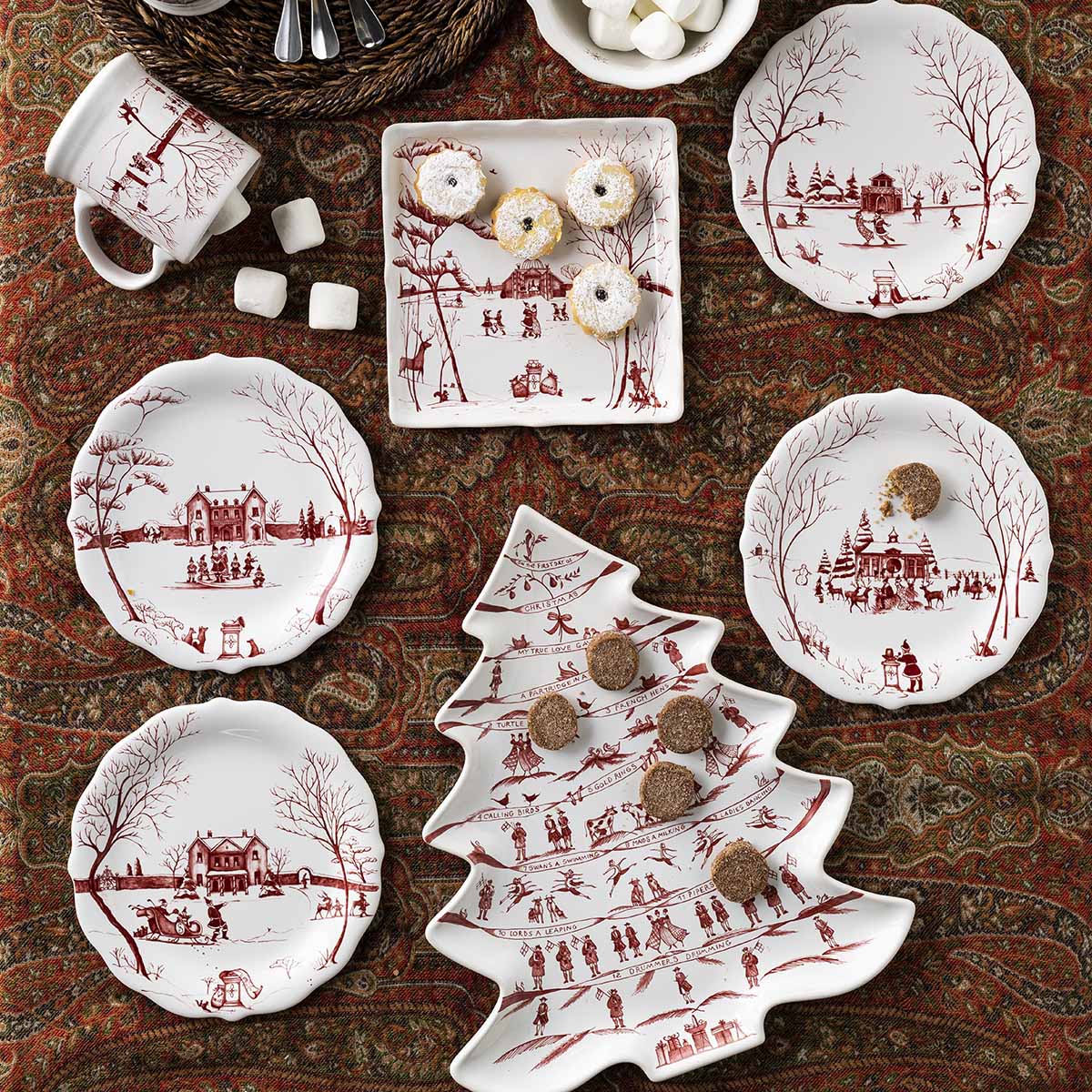 Ruby Winter Frolic tree platter and plates on a paisley tablecloth