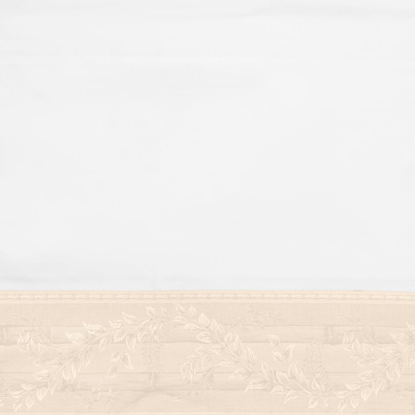 Close-up of ivory and champagne woven leaf border detail on Home Treasures Bamboo linen.