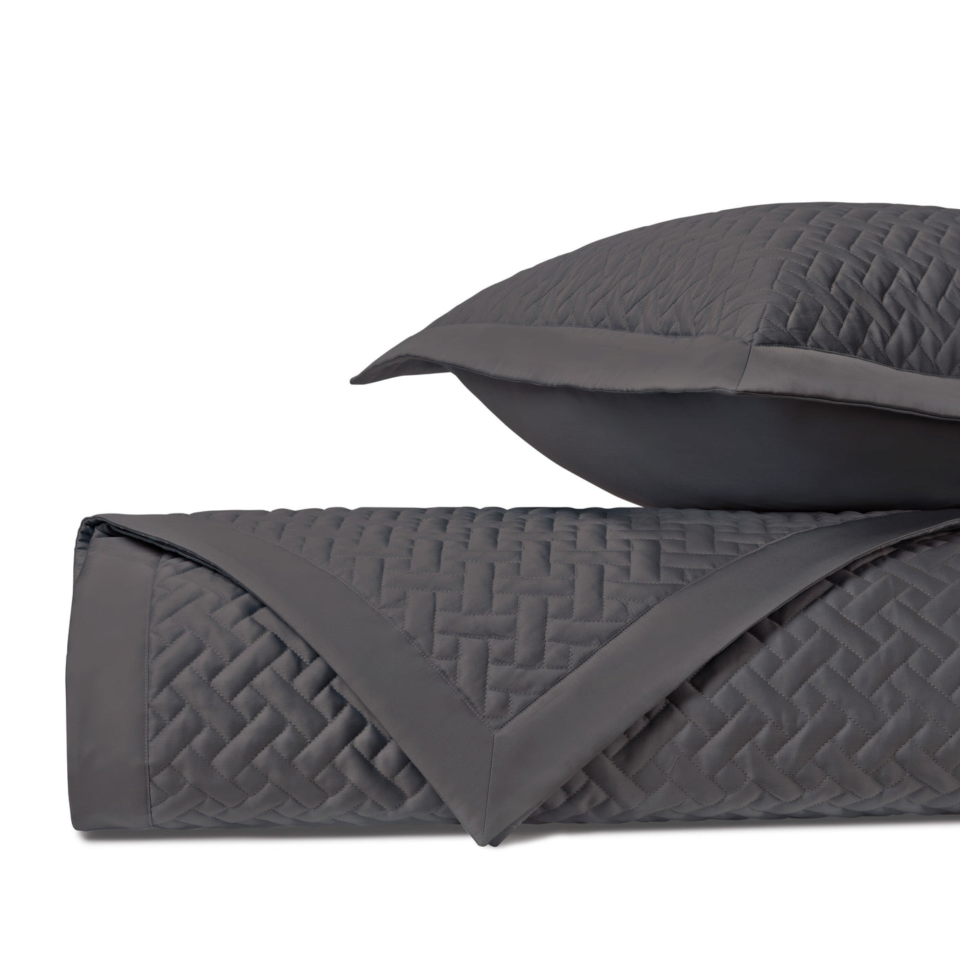 Charcoal quilted basketweave texture detail on folded coverlet and sham.