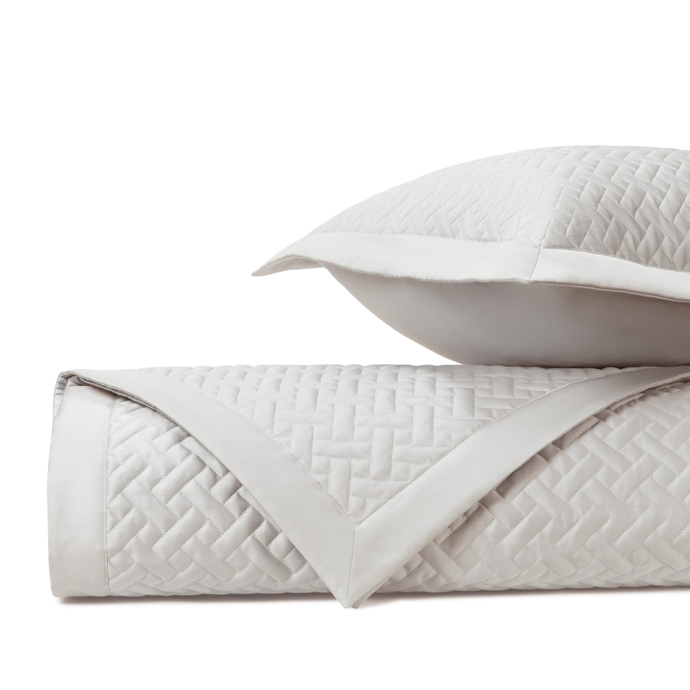 Close-up of Home Treasures Basketweave quilted texture in ivory with satin border trim.