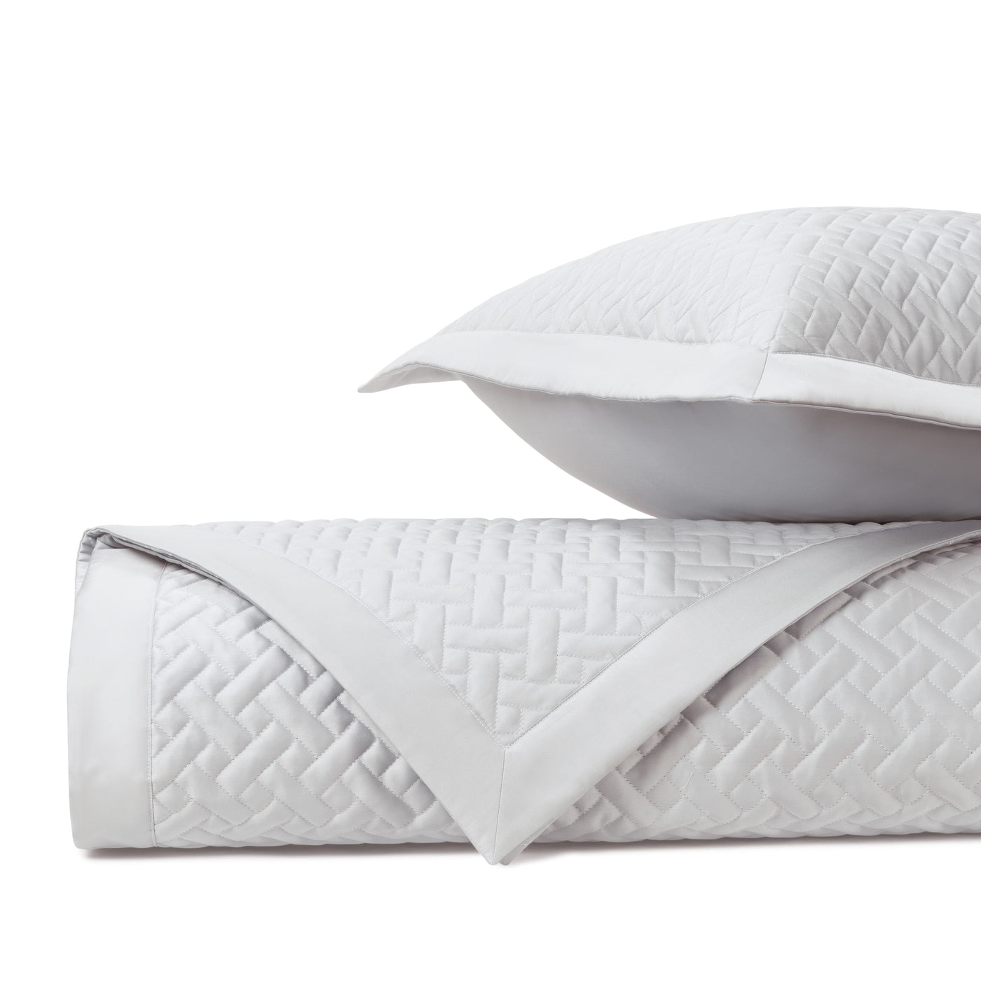 Close-up of Home Treasures Basketweave quilted texture in white with satin border trim.