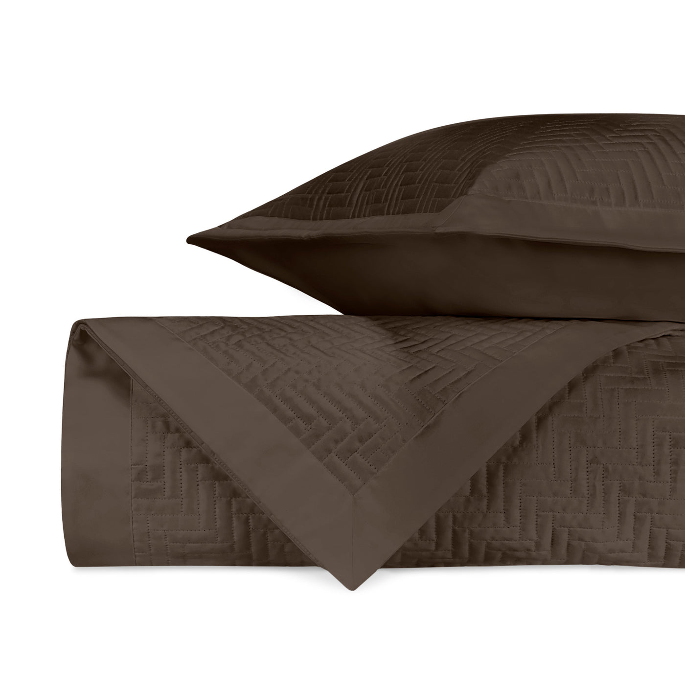Close-up of Baxter quilted coverlet in chocolate with geometric basket-weave stitching.