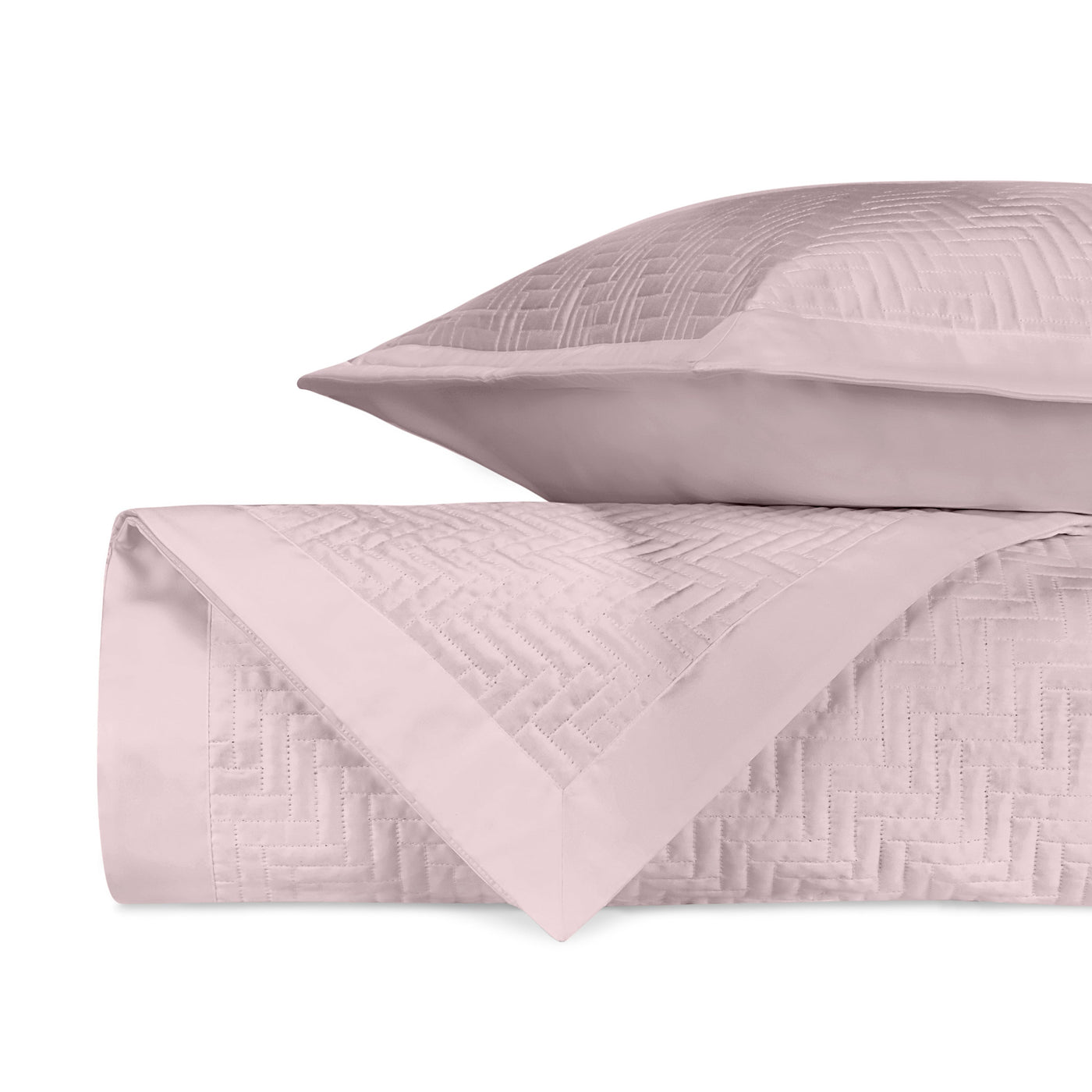 Close-up of Baxter quilted coverlet and sham in blush with herringbone stitch pattern.