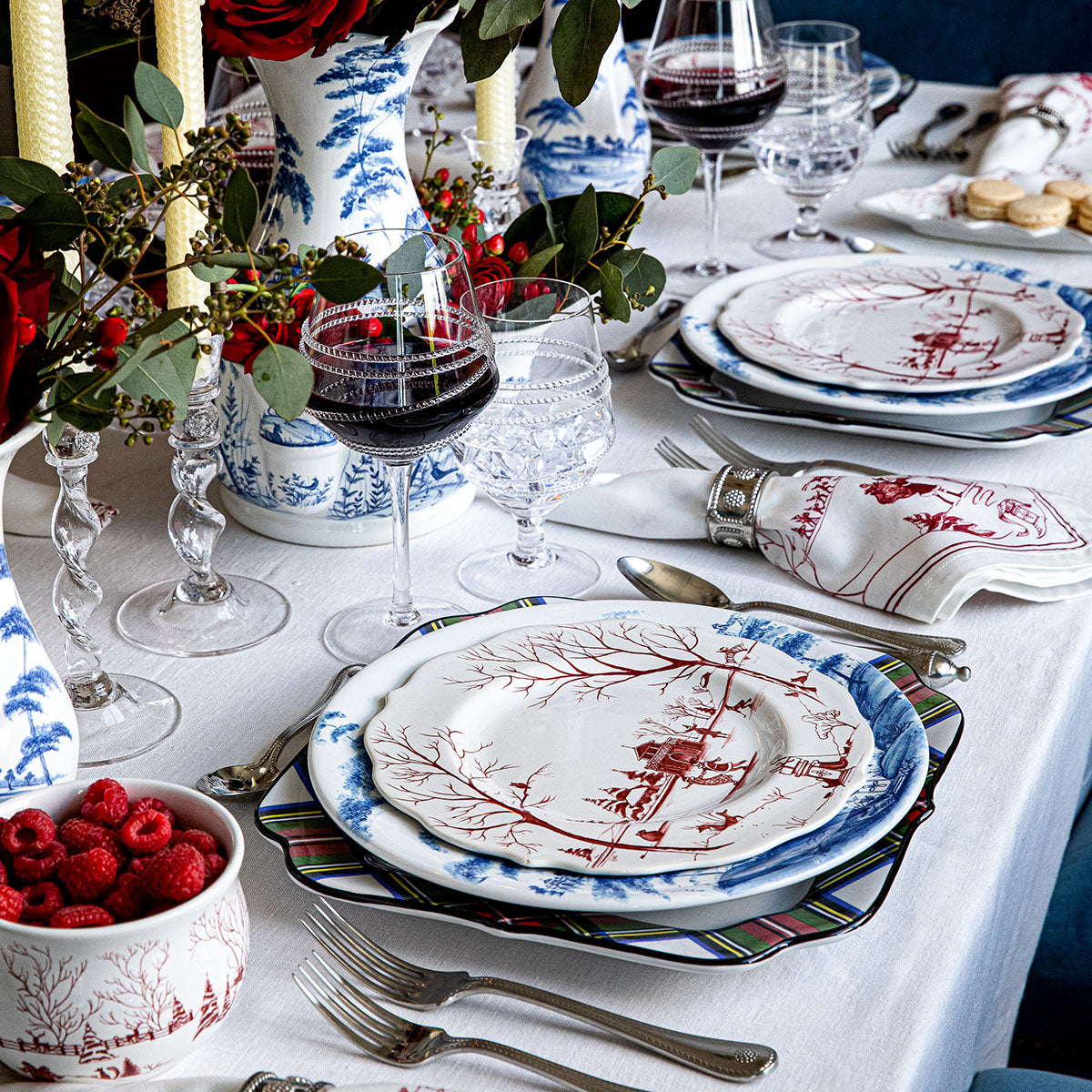 Ruby Winter Frolic salad plate layered on blue and white plates at a holiday table