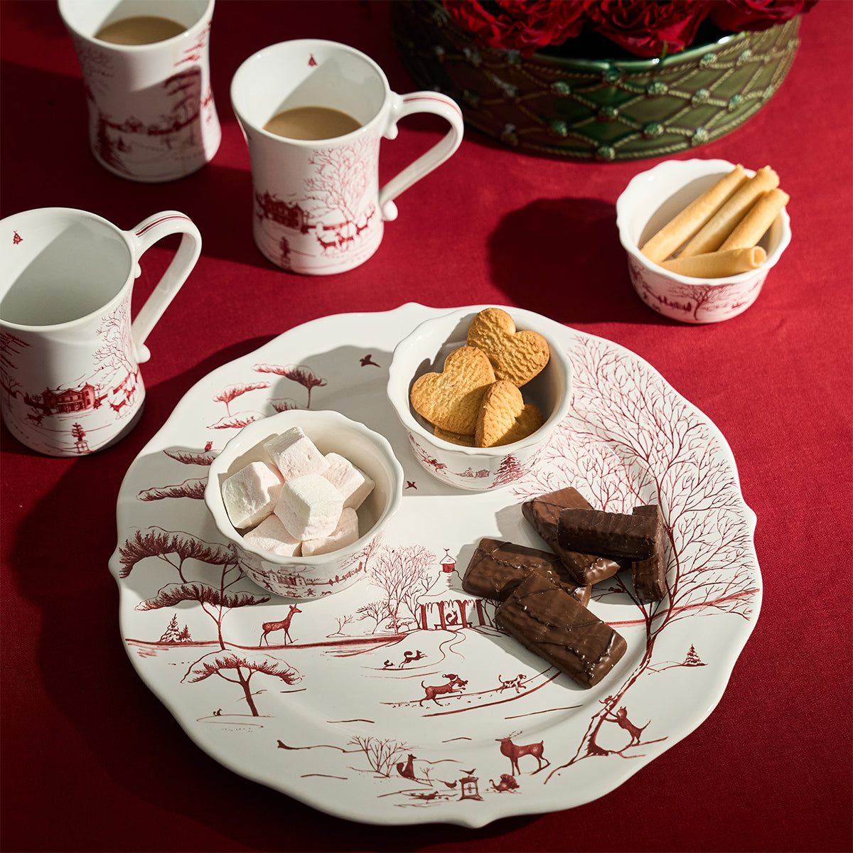 Ruby Winter Frolic charger holding cookies and fudge on a red tablecloth