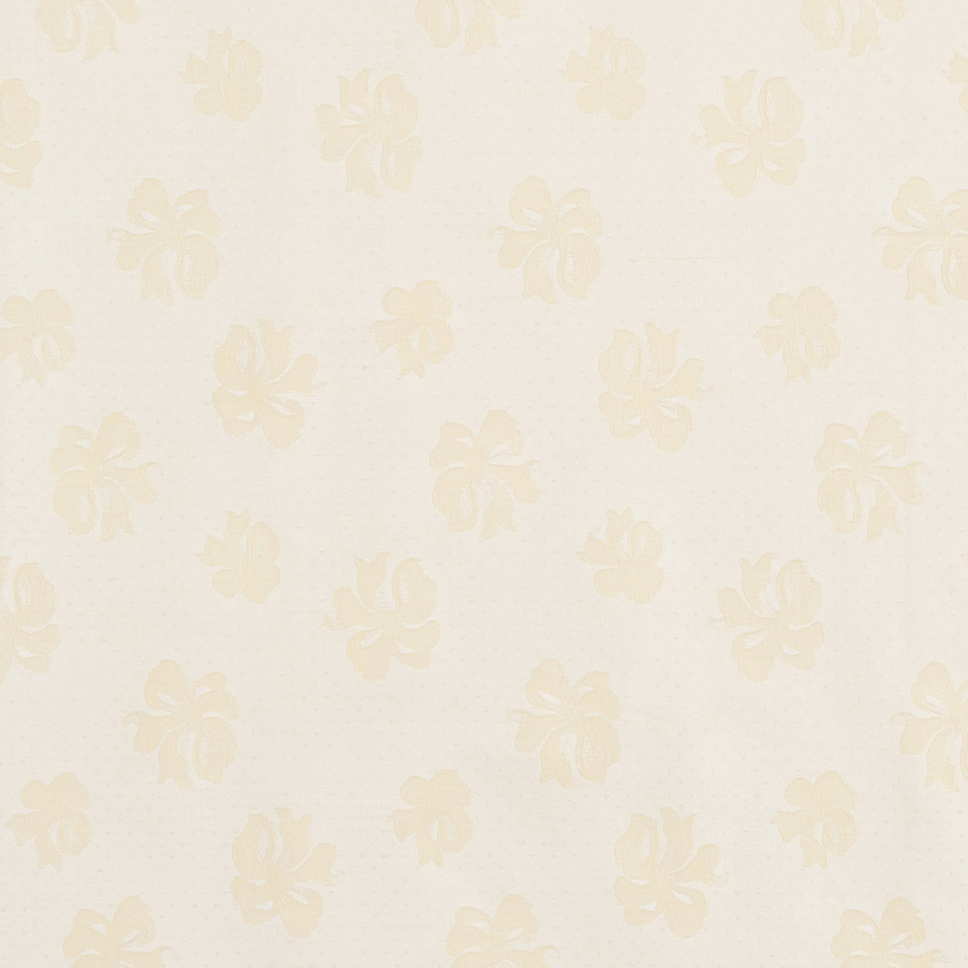 Close-up of champagne floral jacquard weave on ivory cotton fabric.