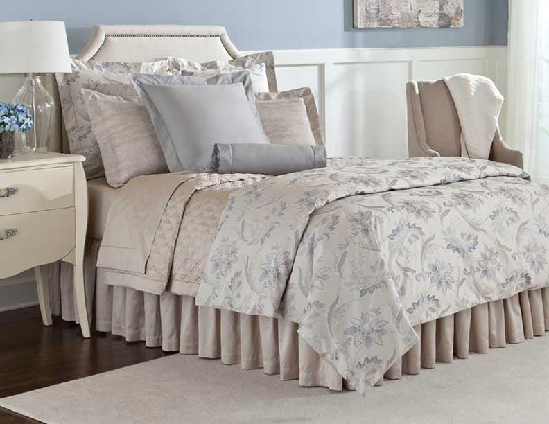 Home Treasures Fiori bedding in ivory and blue floral jacquard on styled bed.