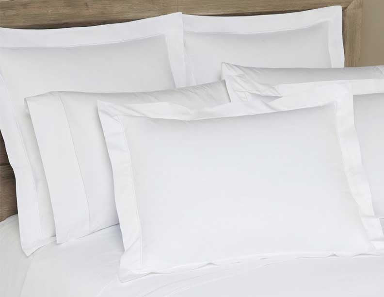 White cotton yardage fabric draped and folded, showing smooth texture and clean finish.