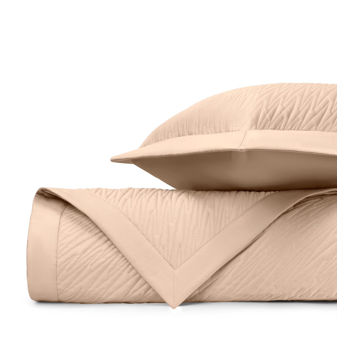 Close-up of Home Treasures Blaze quilted texture in warm sand with subtle wave stitching.