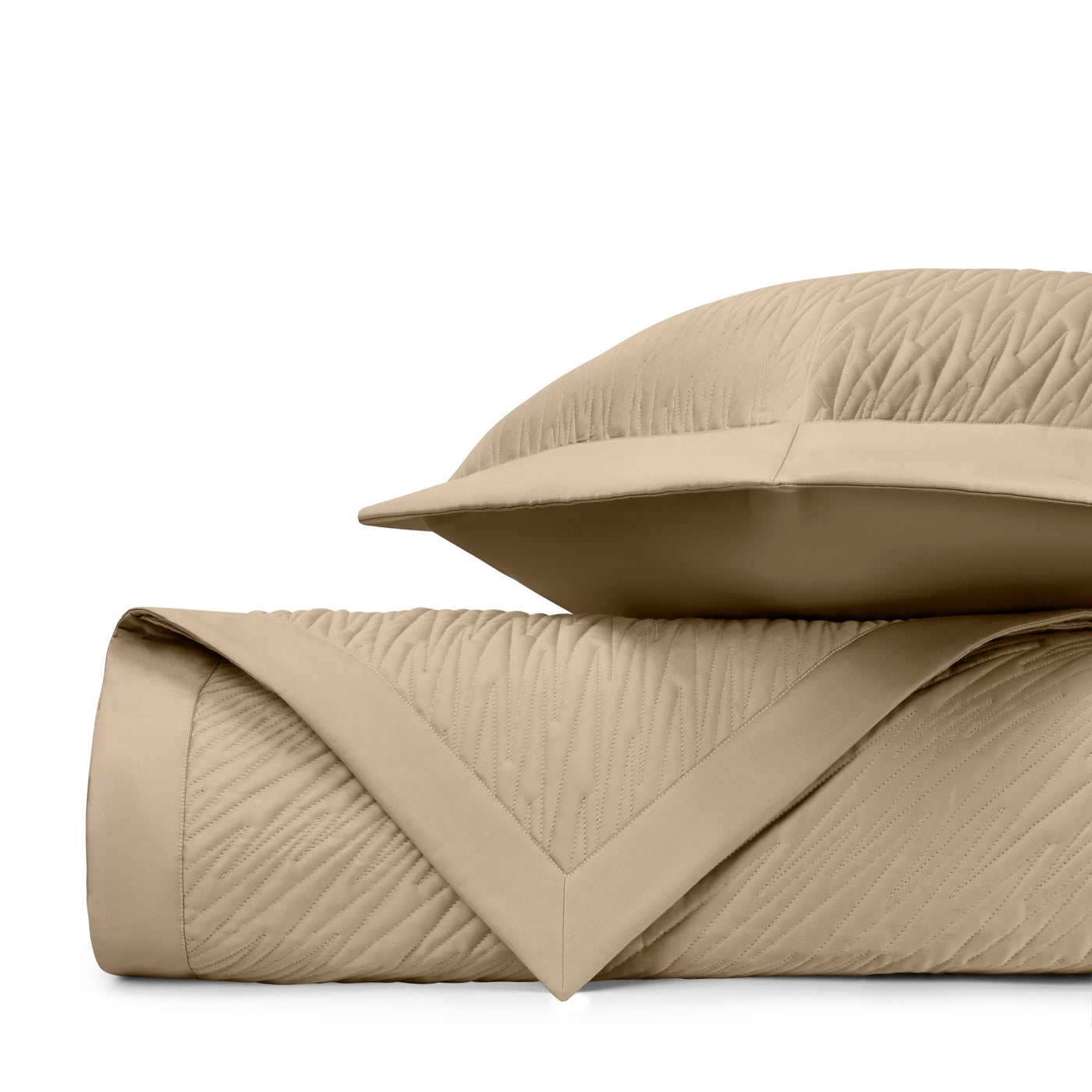 Close-up of Home Treasures Blaze quilted fabric in warm camel with wave-stitched texture.