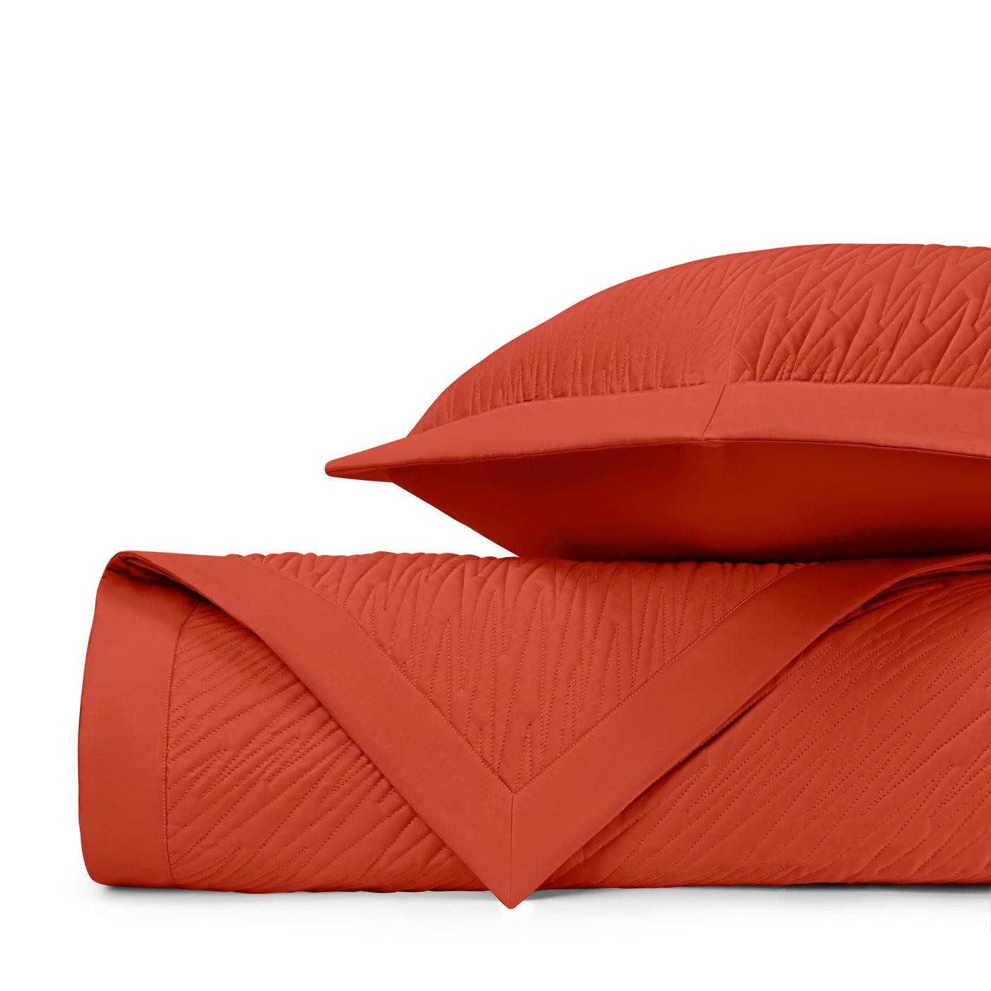 Close-up of Home Treasures Blaze quilted texture in tomato red with wave stitching.