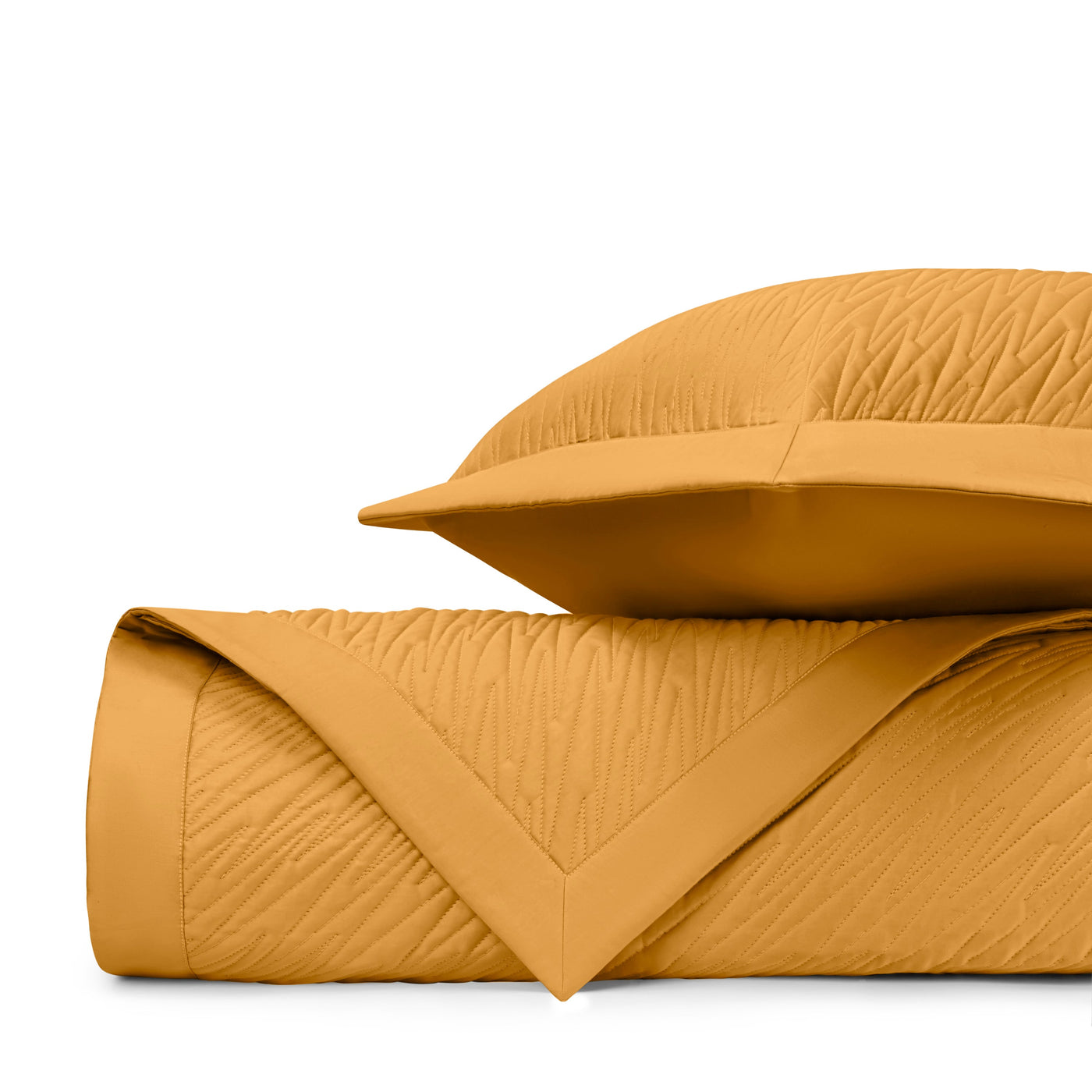 Close-up of honey gold quilted texture with wave stitching pattern and mitered corner detail.