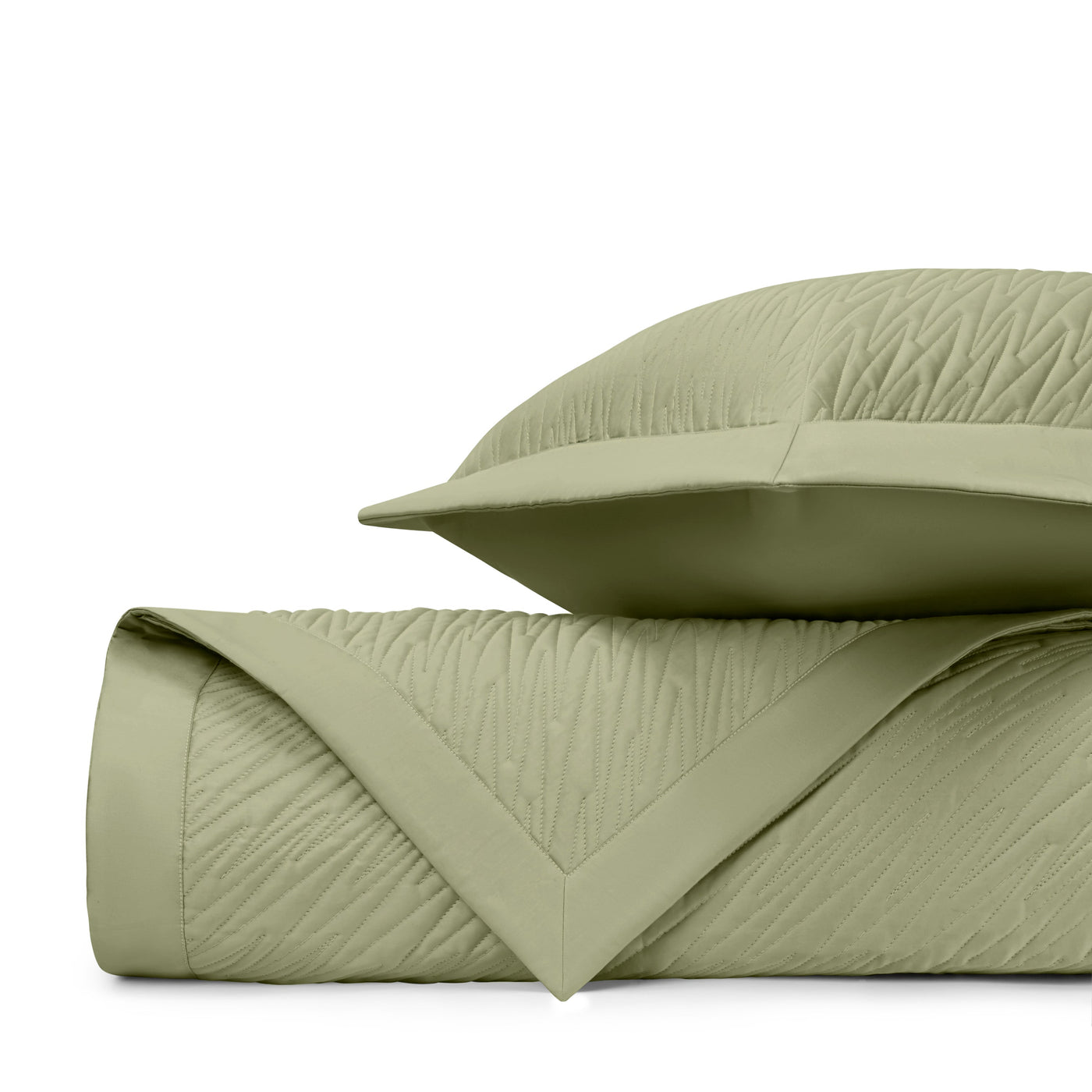 Close-up of sage green quilted texture with wave-stitched pattern and mitered corner detail.