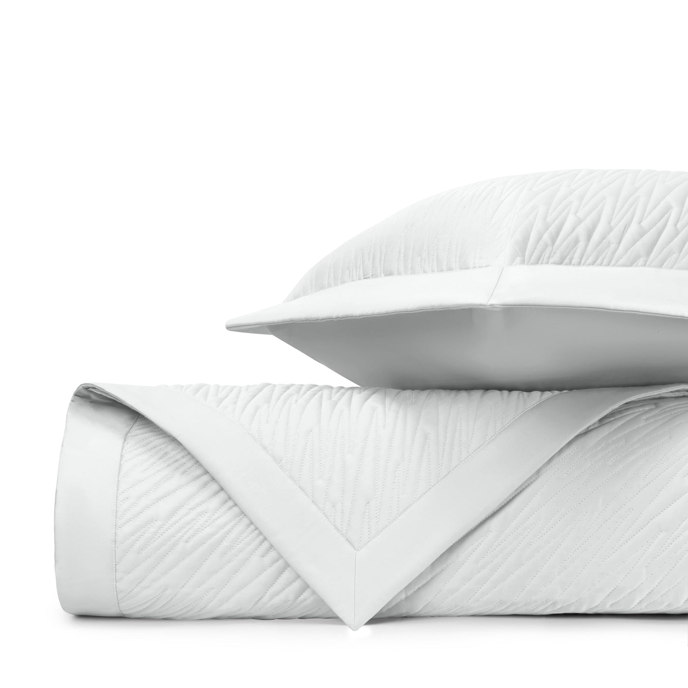 Close-up of Home Treasures Blaze quilted texture in white with wave-pattern stitching.