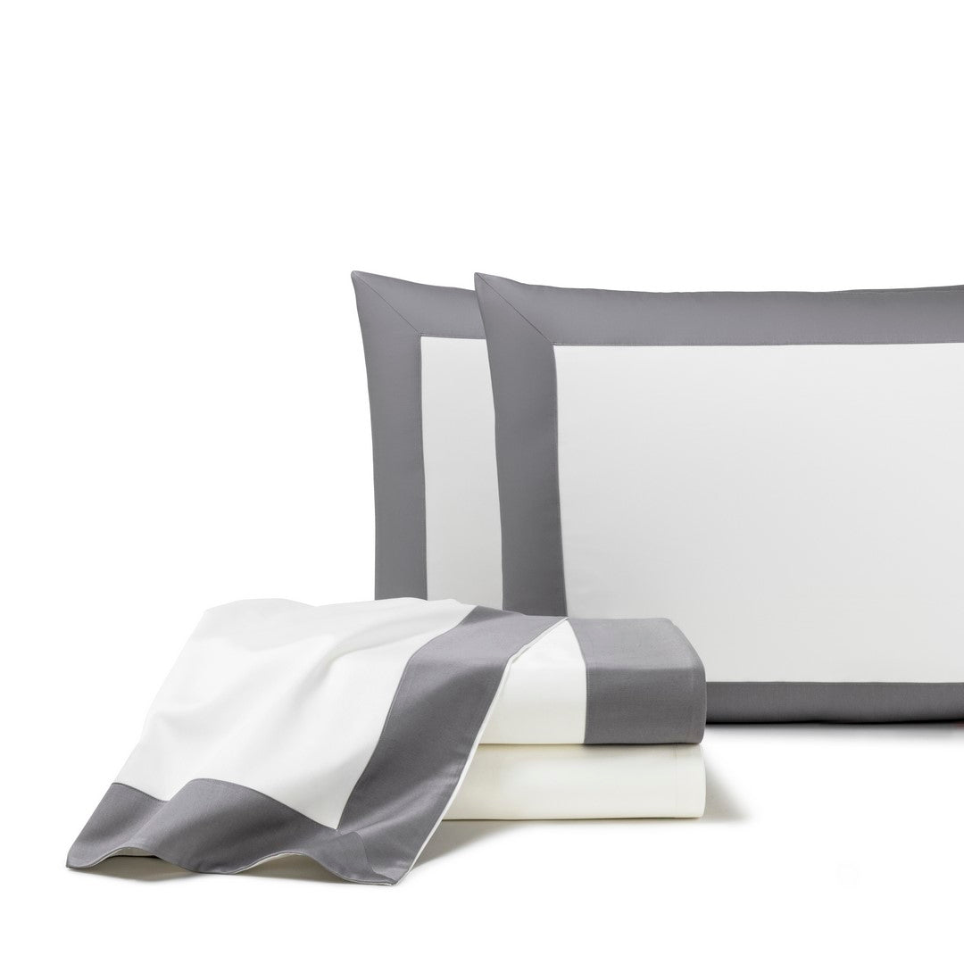 The Frette Bold | Sheet Set, featuring a gray border, includes two matching pillowcases and a flat sheet, all neatly arranged against a white background for a contemporary bedroom style.