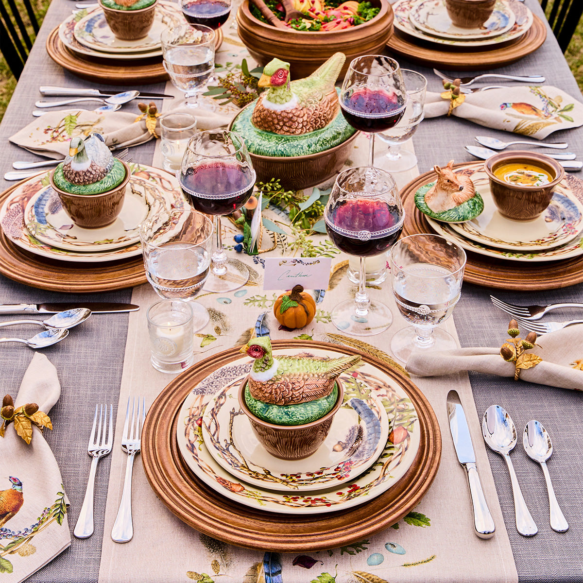 Overhead of a table set with Forest Walk plates and pheasant lidded bowls at each place