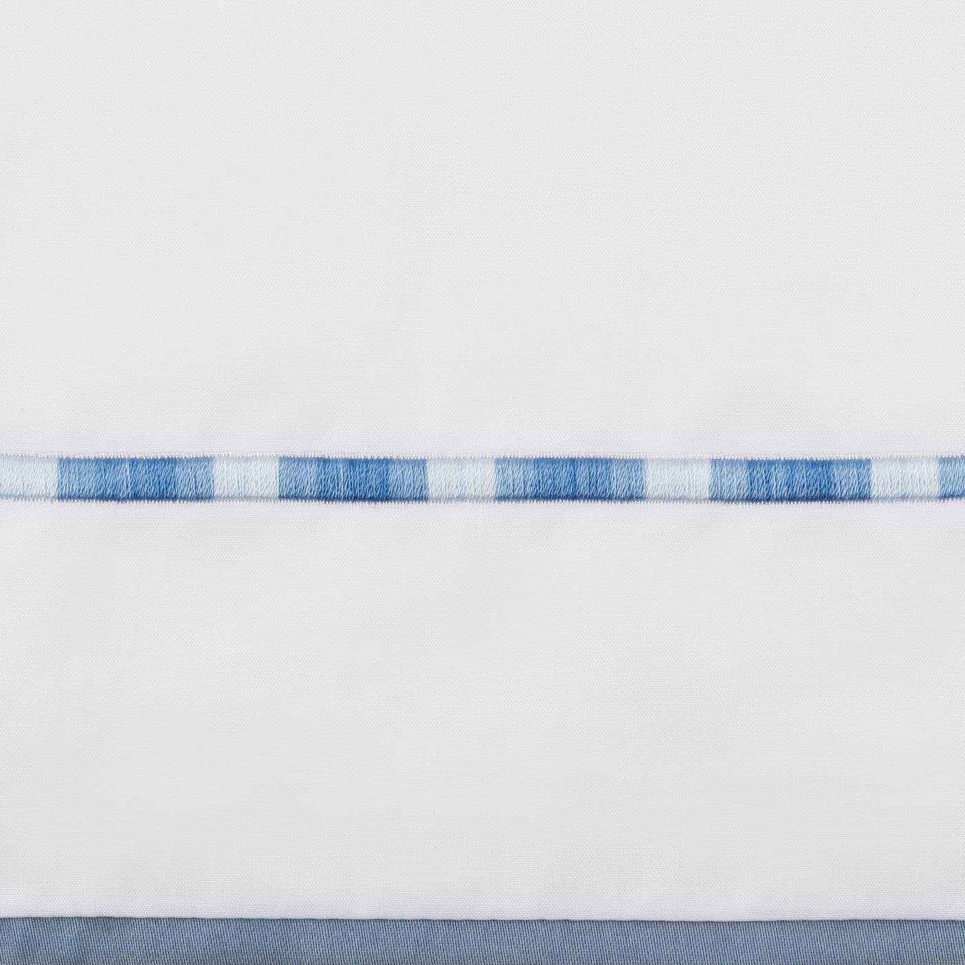 Close-up of Home Treasures Calypso embroidered blue and white check border detail.