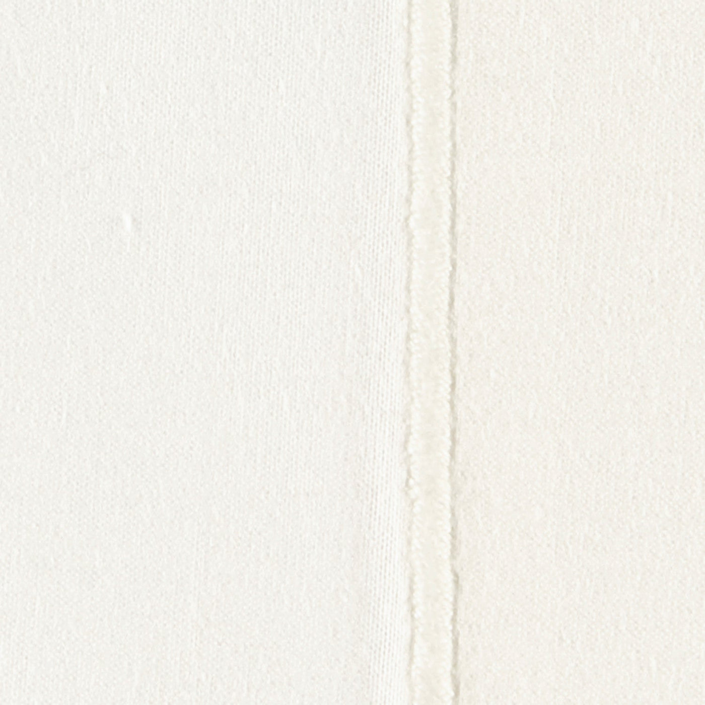Close-up of ivory linen-weave fabric with a raised satin stitch seam detail.