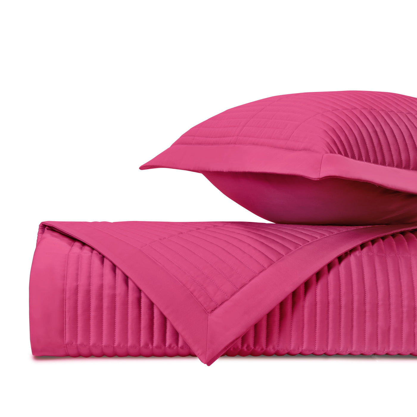 Fuchsia quilted channel-stitch detail on folded coverlet and Euro sham.