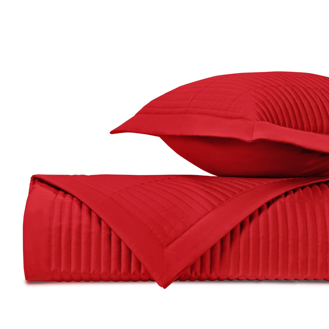 Crimson channel-quilted coverlet and sham, folded to show parallel stitching detail.
