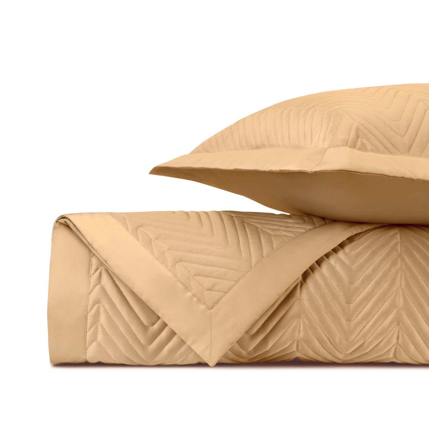 Close-up of Charleston quilted satin in caramel, showing chevron stitch pattern and folded edge.