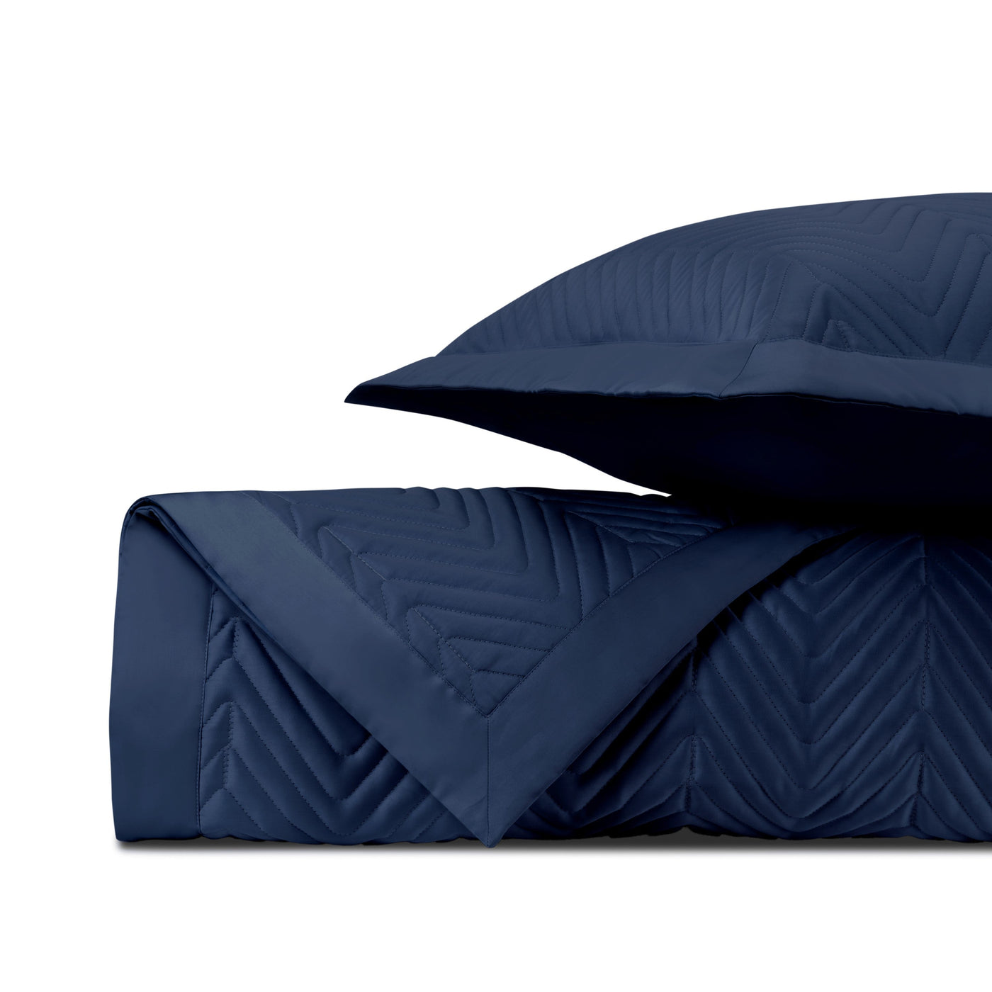 Close-up of navy blue quilted fabric with diagonal chevron stitching pattern.