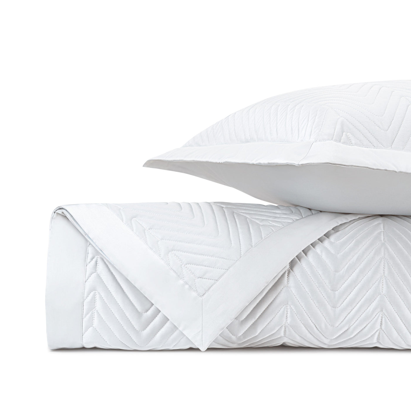 Close-up of white quilted fabric with raised chevron stitching pattern.