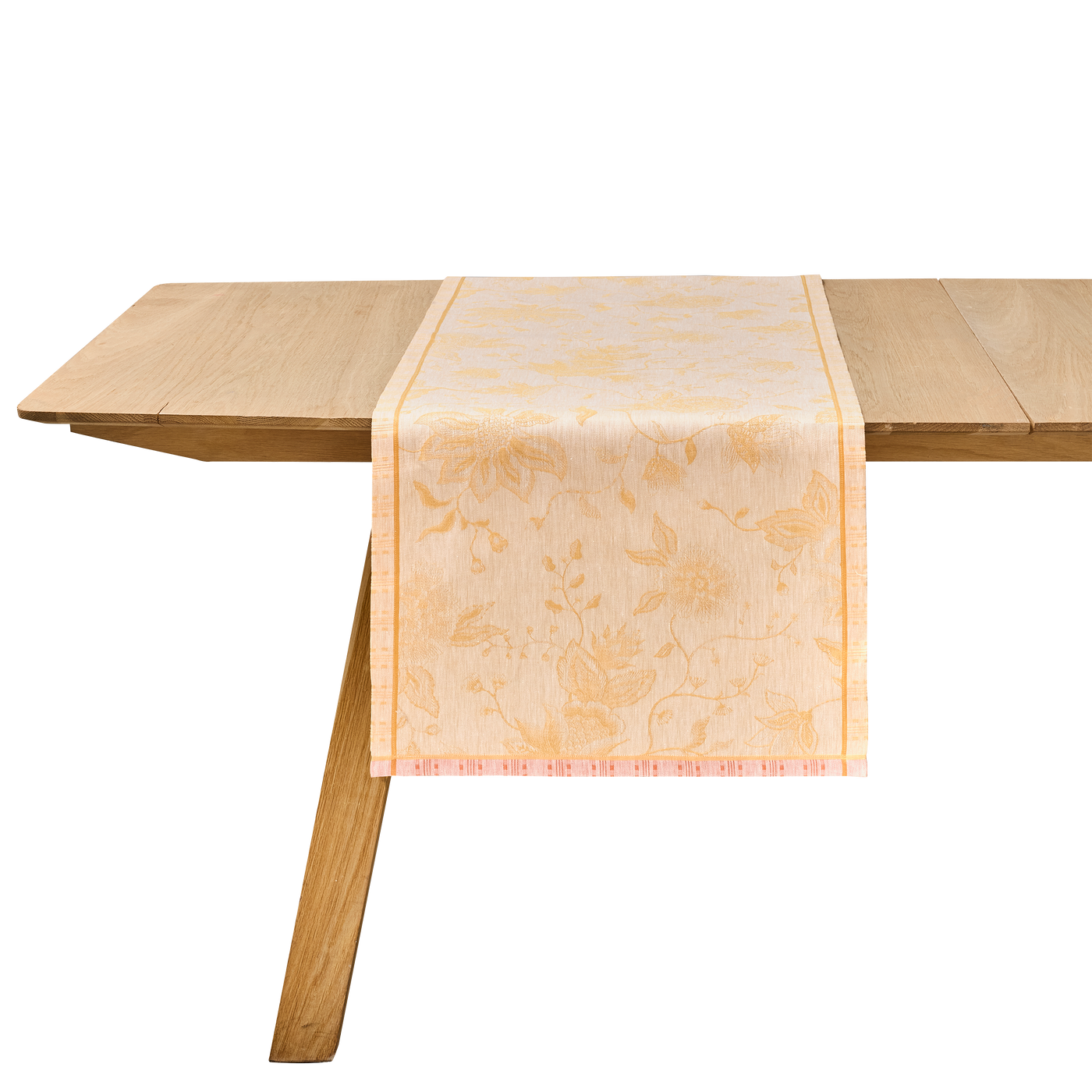 Le Jacquard Français Été Indien champagne jacquard table runner on a wooden table.