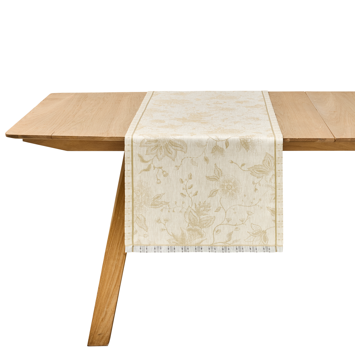 Ivory jacquard table runner with gold floral print draped over a natural oak table.