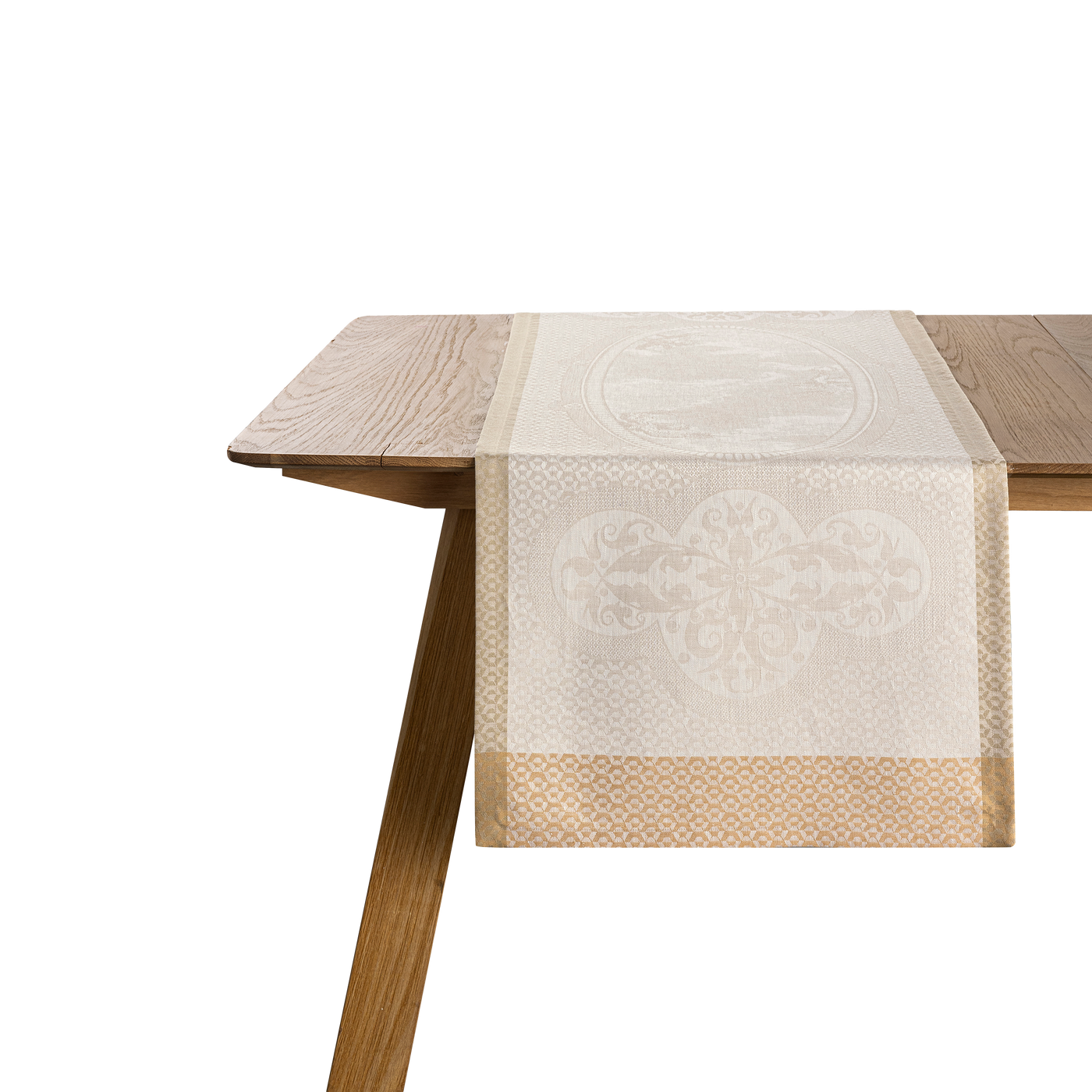 Ivory and champagne jacquard table runner draped over a natural oak dining table.