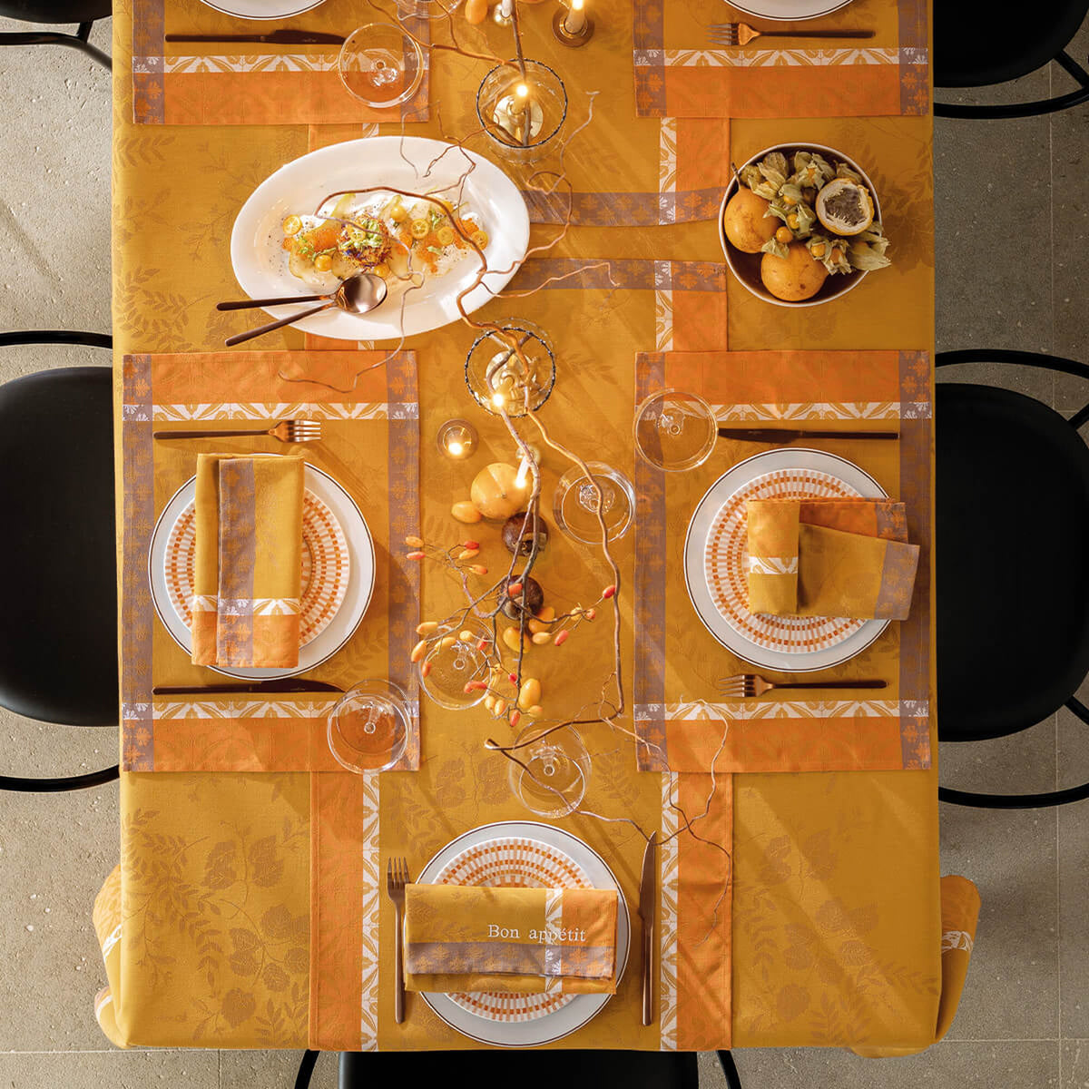 Overhead view of Orange Manor Lane runner on a styled table with matching placemats and napkins.