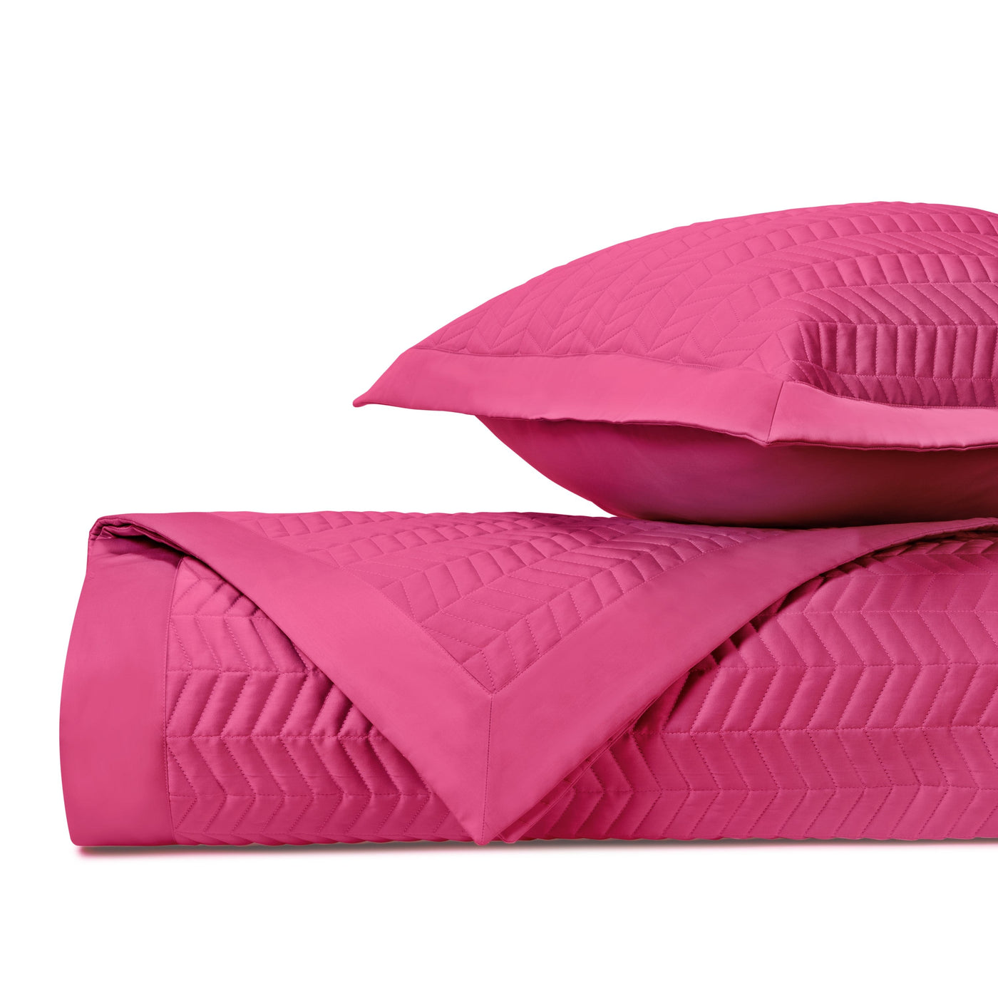 Close-up of Chester quilted satin in fuchsia, showing chevron stitch pattern detail.