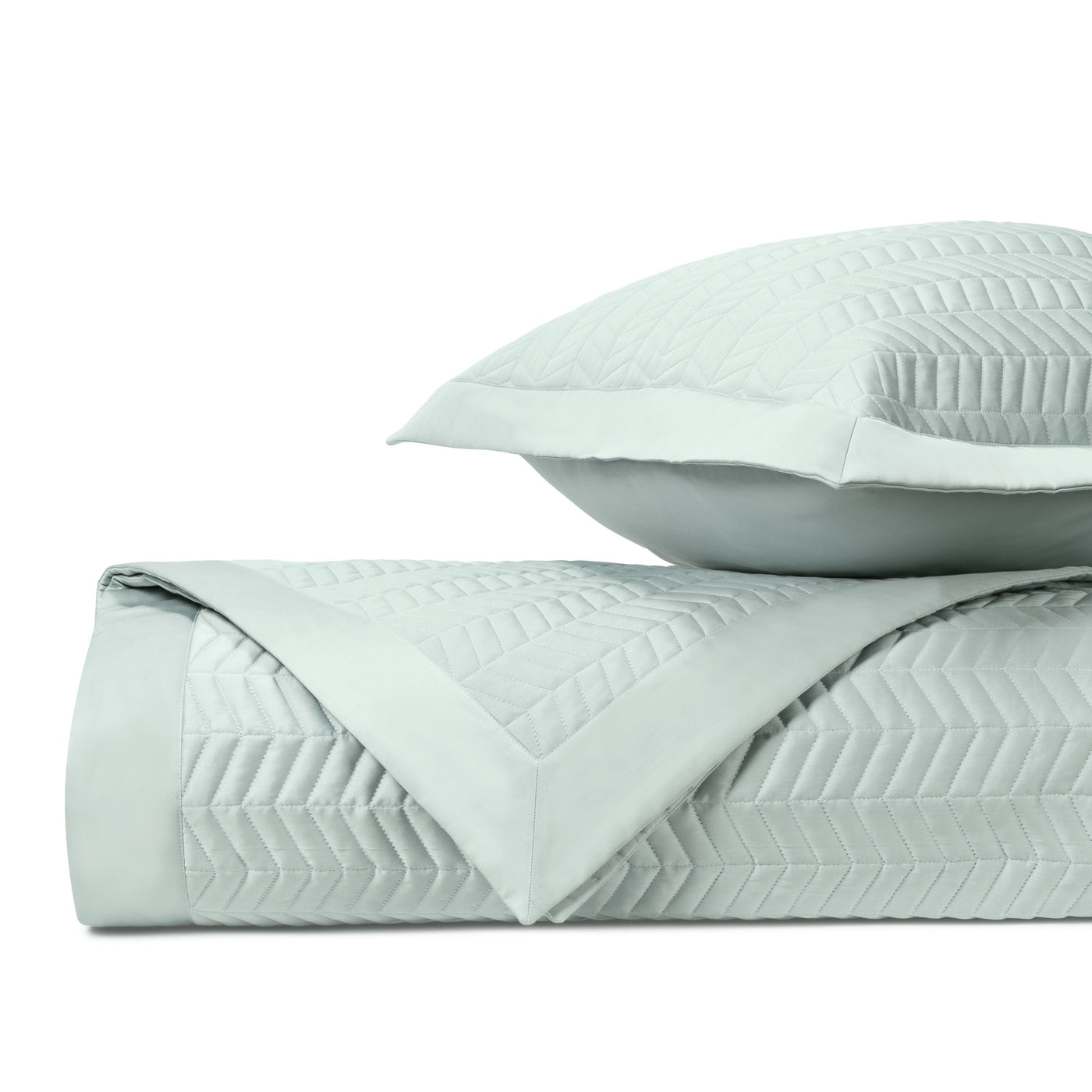 Close-up of Chester quilted cotton in pale aqua, showing chevron stitching texture.