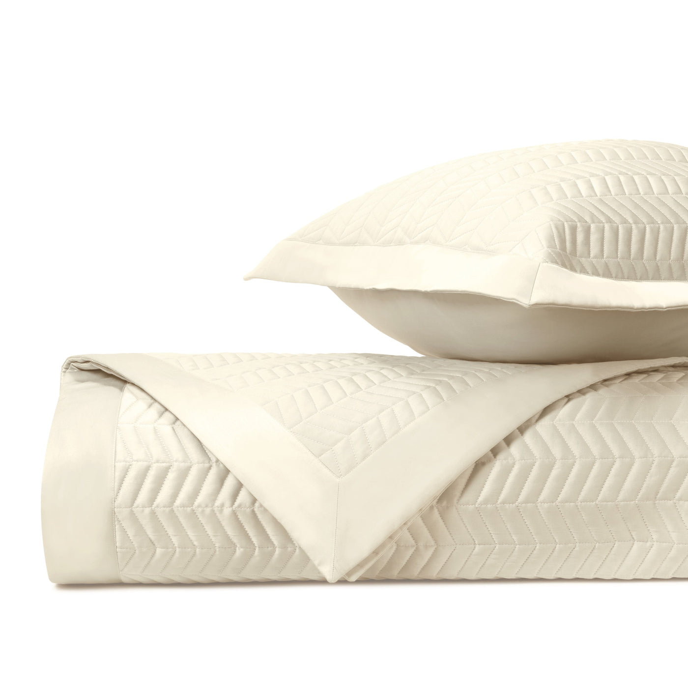 Close-up of ivory quilted chevron texture on folded Chester bedding set.