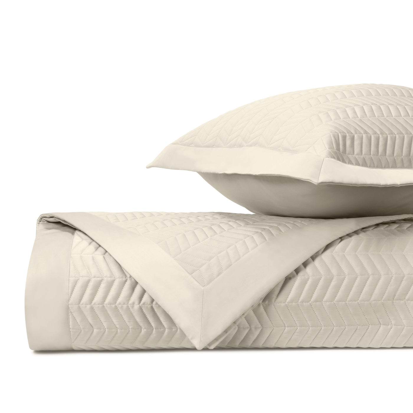 Close-up of ivory quilted herringbone texture on Chester coverlet and sham.