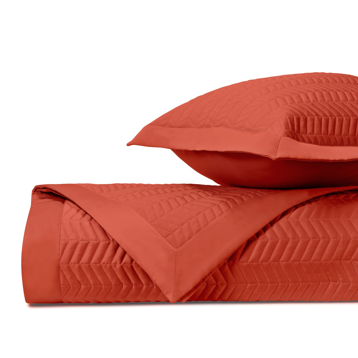 Close-up of Chester quilted texture in tomato red with chevron stitching pattern.