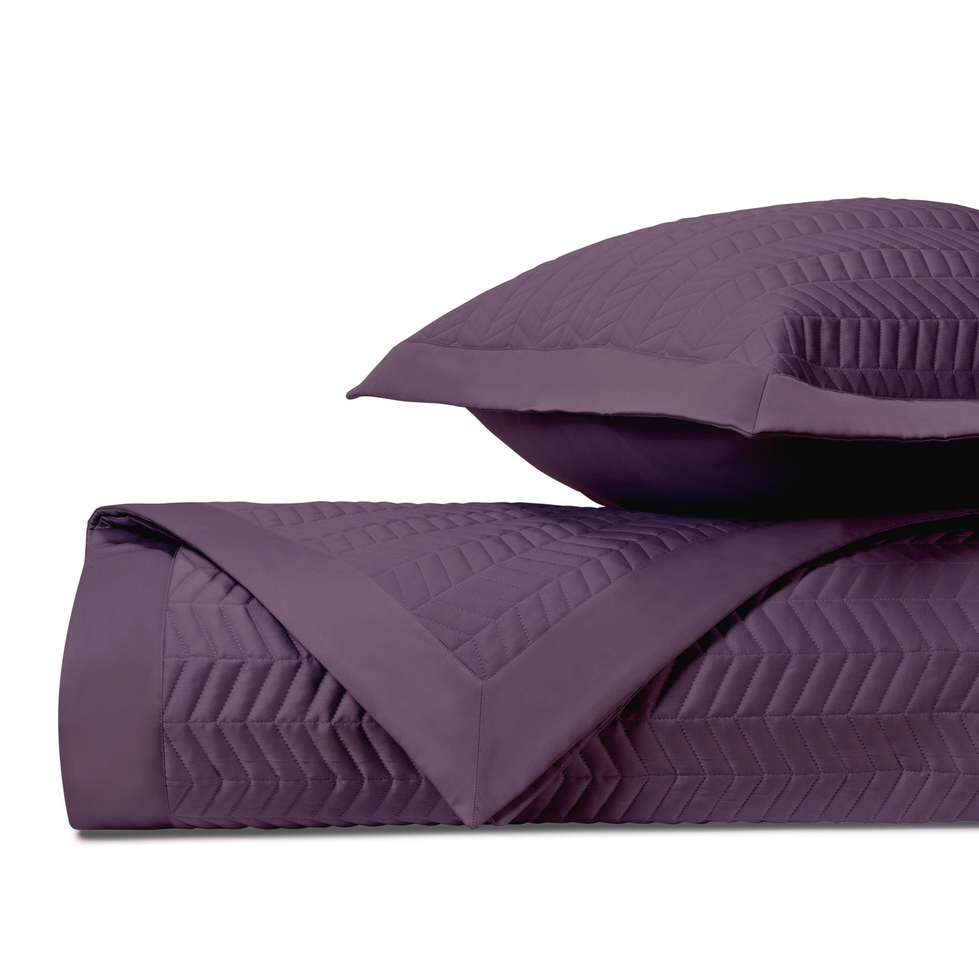 Close-up of Home Treasures Chester quilted texture in deep plum with chevron stitching.
