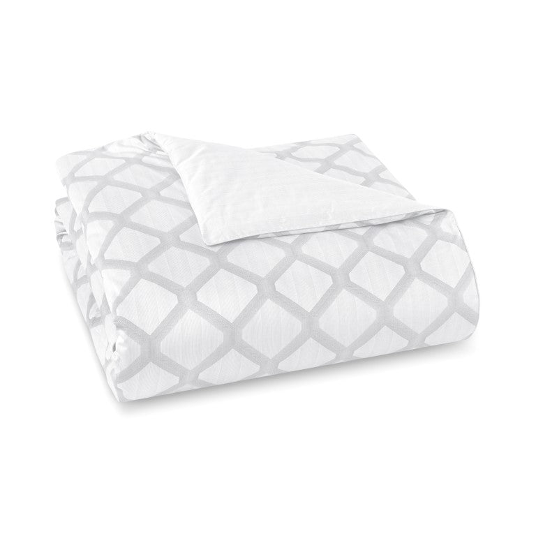 Folded duvet cover showing silver geometric lattice pattern on white ground, reverse in solid white.