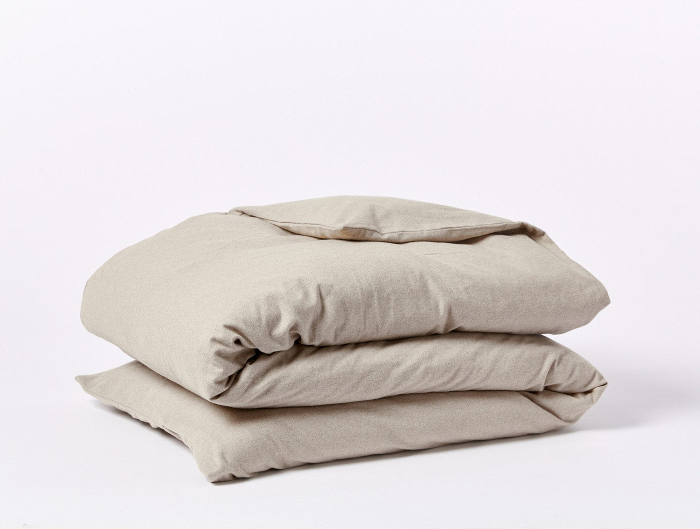 Coyuchi Cloud Brushed Flannel duvet cover folded in natural linen, showing soft texture.