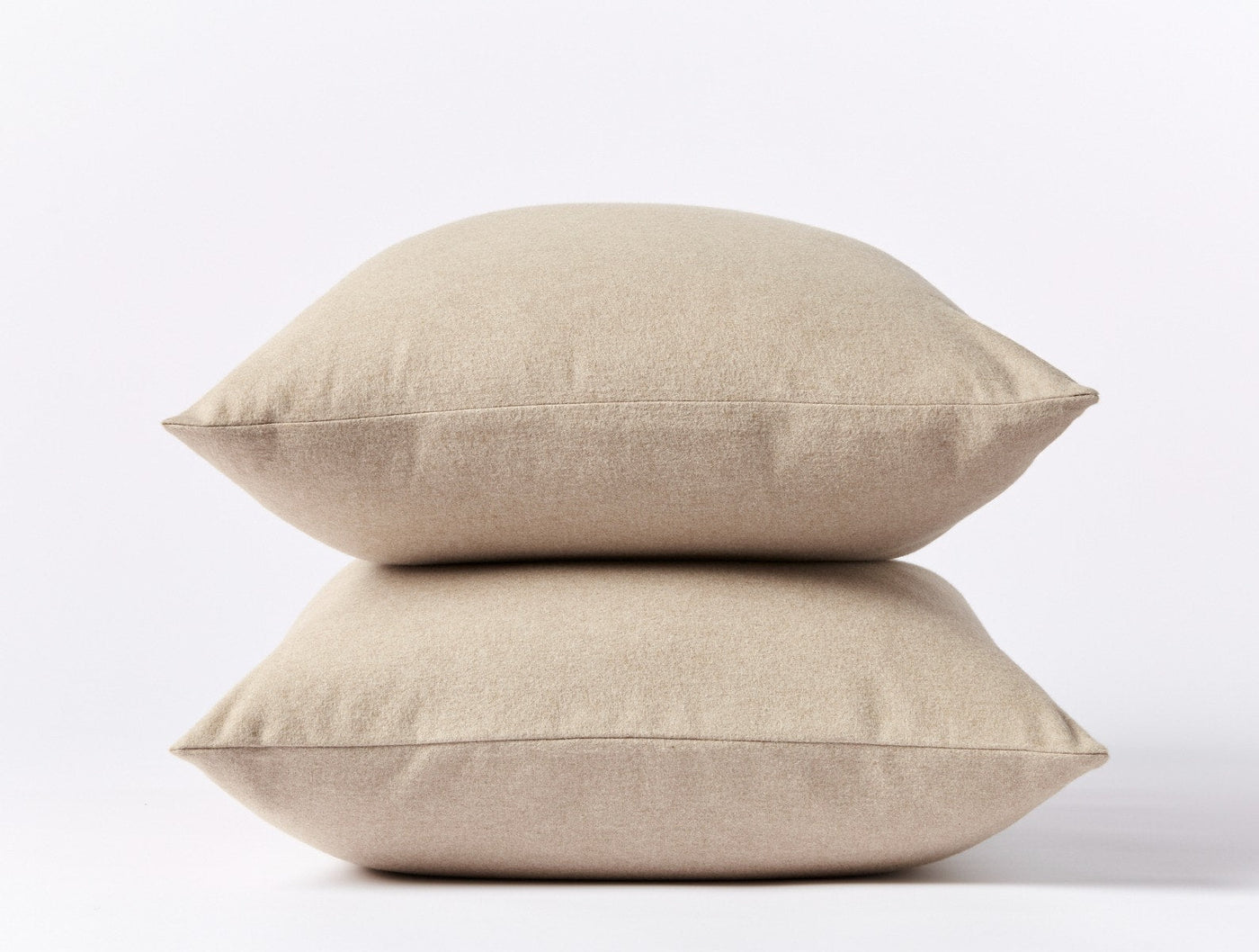 Two stacked oatmeal brushed flannel pillow shams against a white background.
