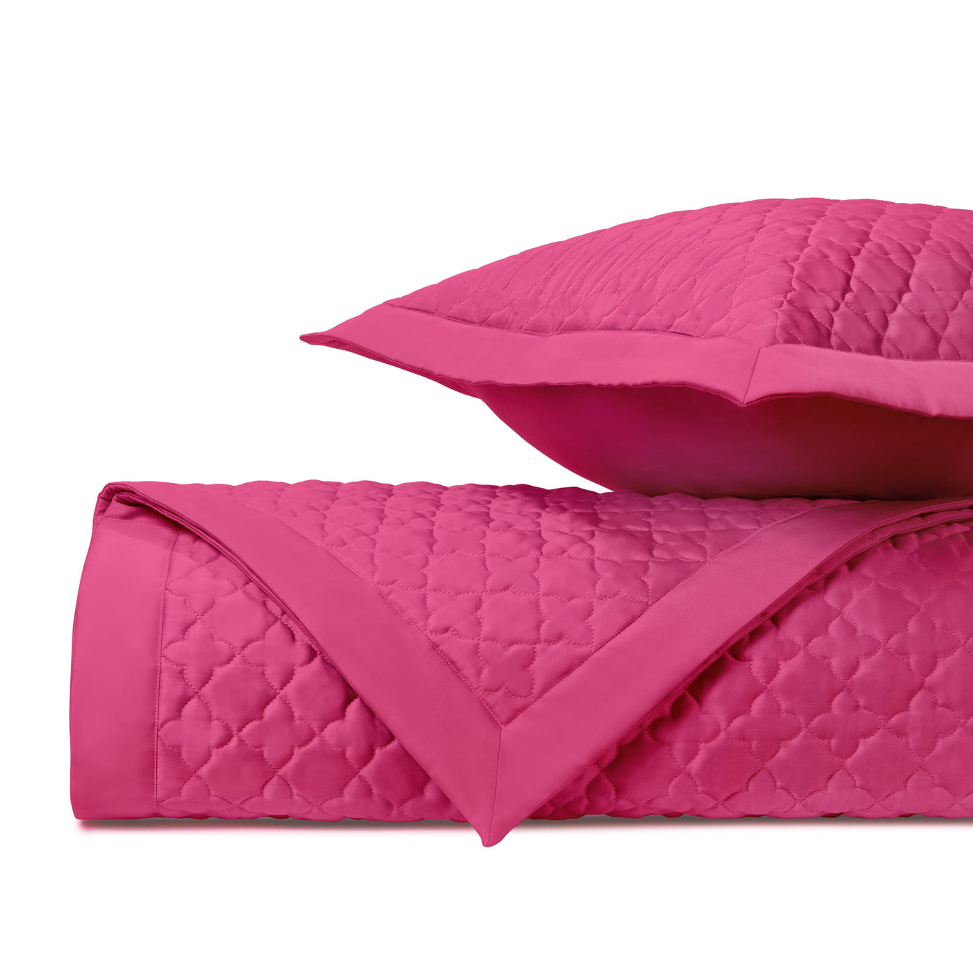 Close-up of Home Treasures Clover quilted coverlet in fuchsia with trellis stitching.